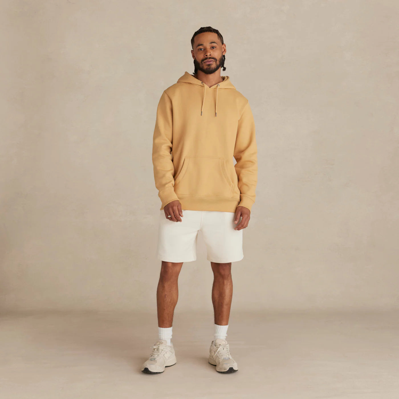 EMERCYN Essential Hoodie –Man wearing a mustard butter yellow unisex premium cotton hoodie