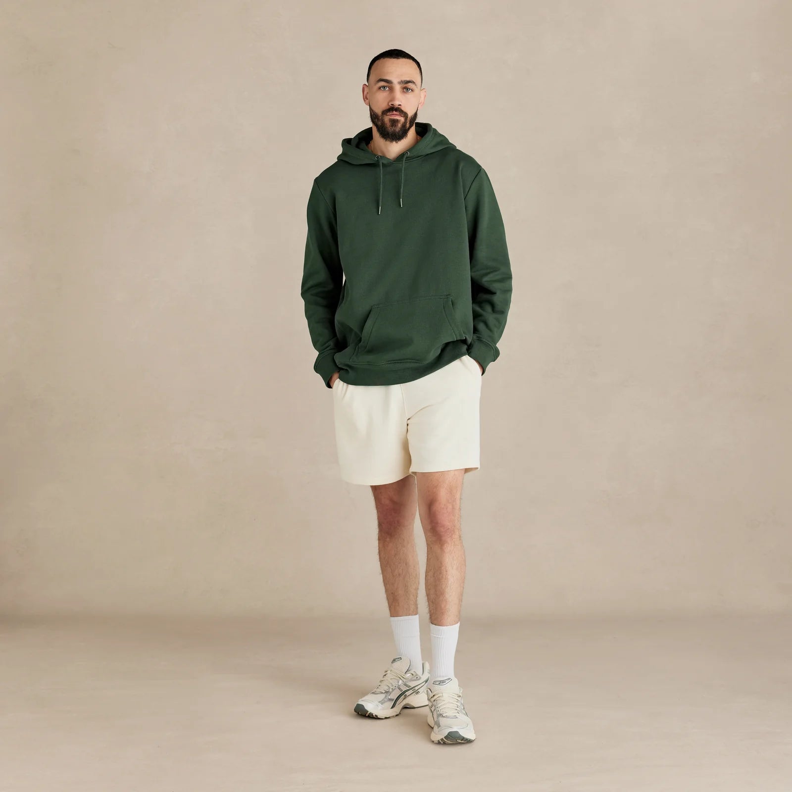 EMERCYN Essential Hoodie – forest green men’s premium cotton hoodie styled on male model