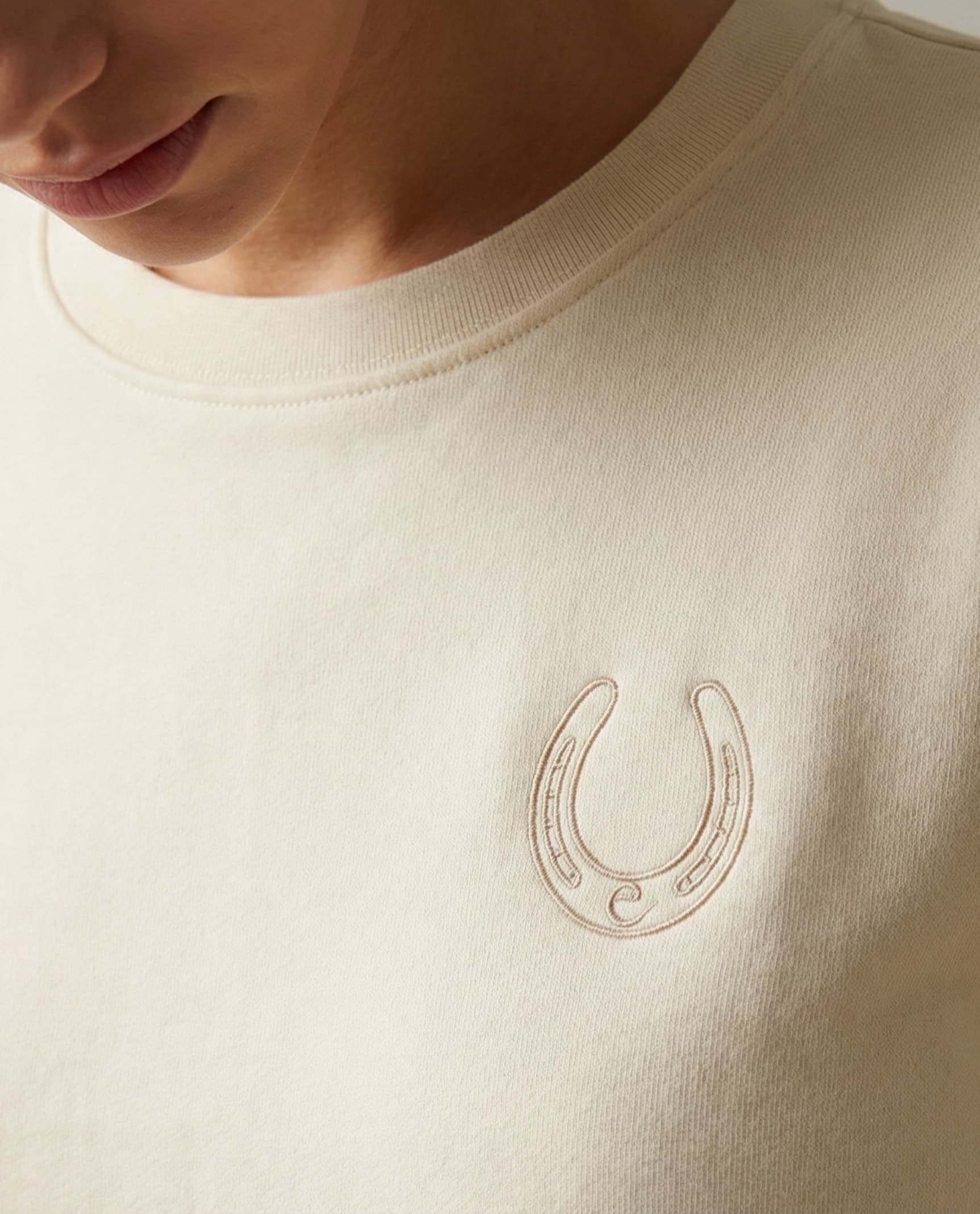 close up of sustainable cotton sweatshirt with custom embroidery logo for private label apparel production