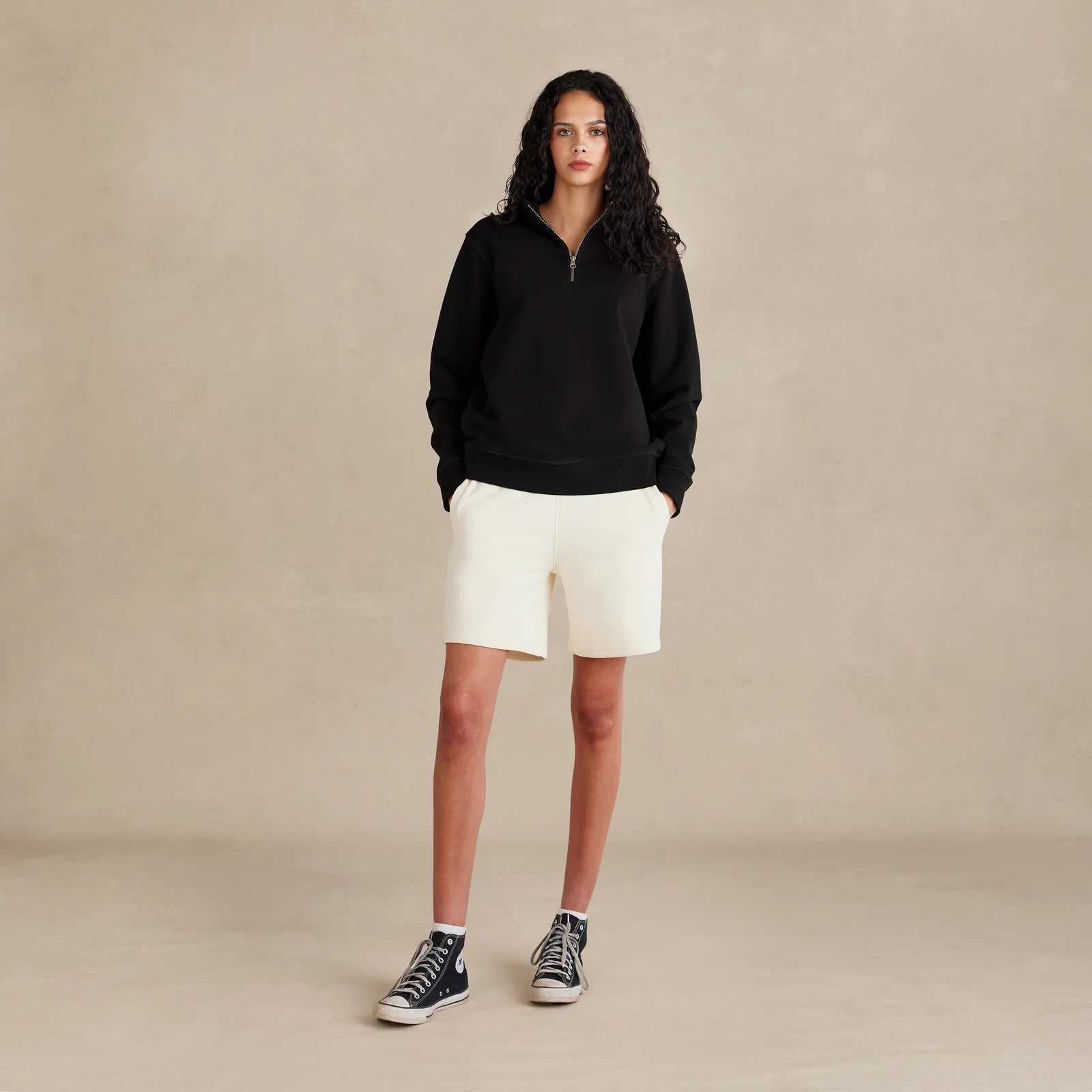 The Traveler Pullover black sweatshirt worn by female model