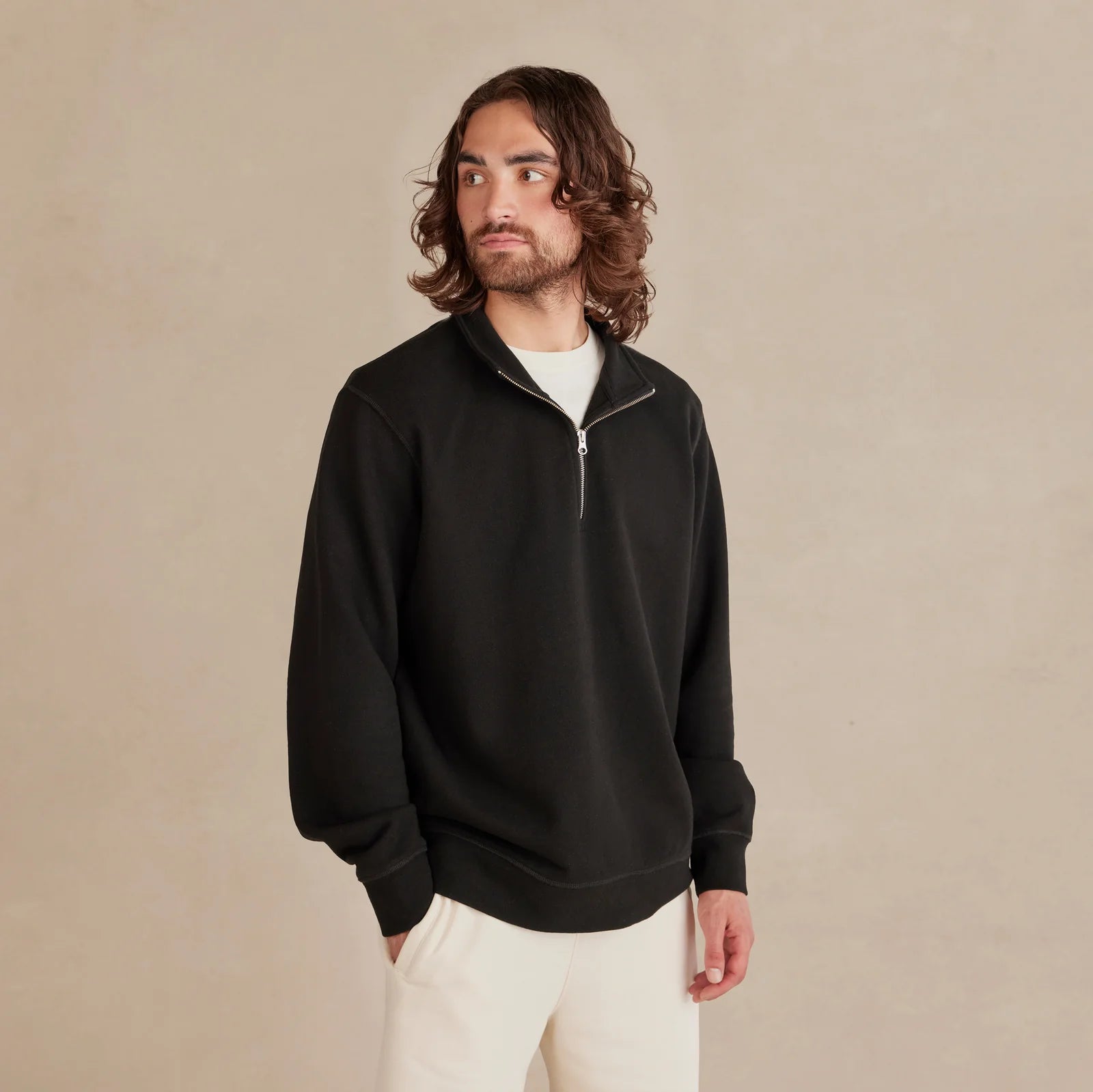 The Traveler Pullover black sweatshirt worn by male model portrait