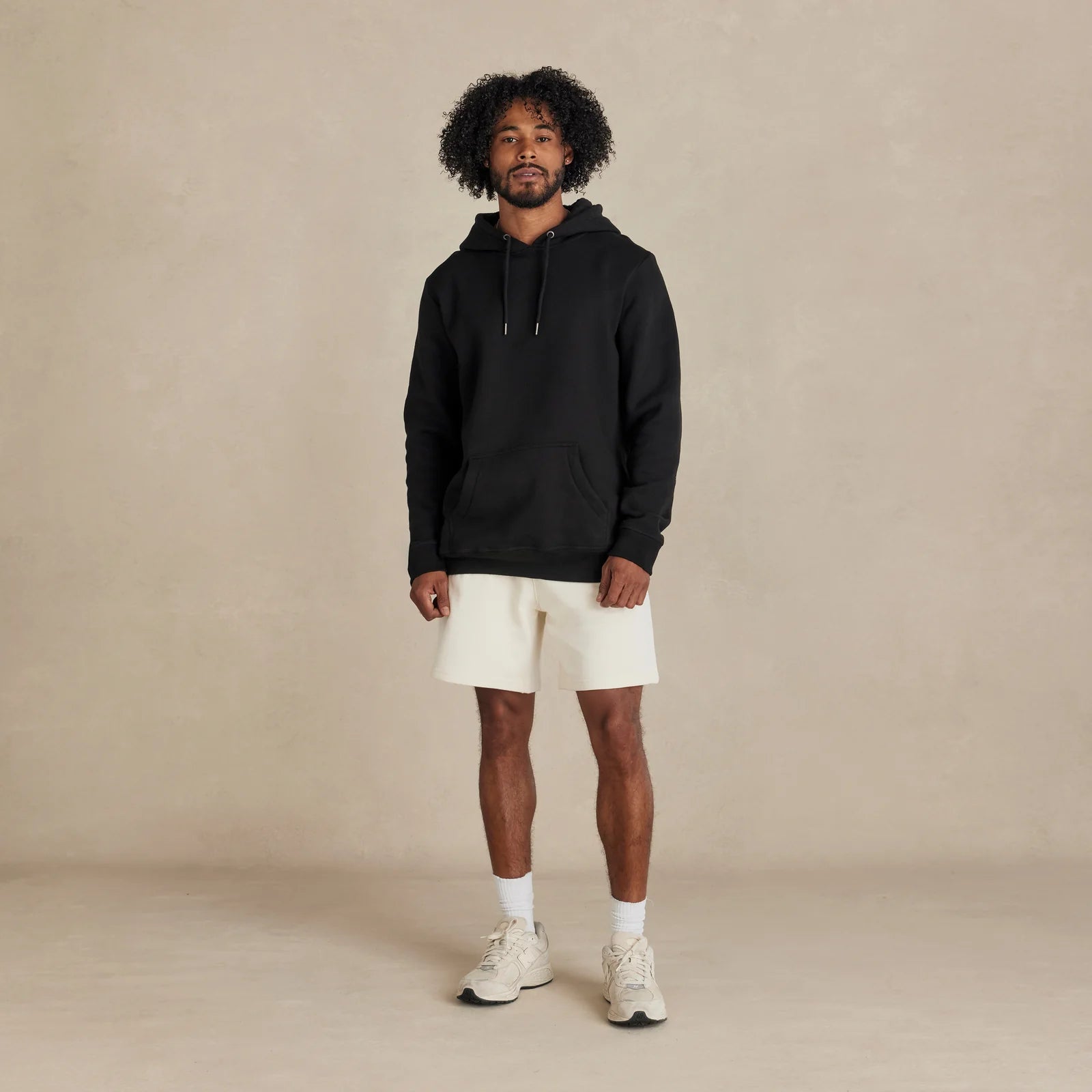 EMERCYN Essential Hoodie – black men’s premium cotton hoodie styled on male model
