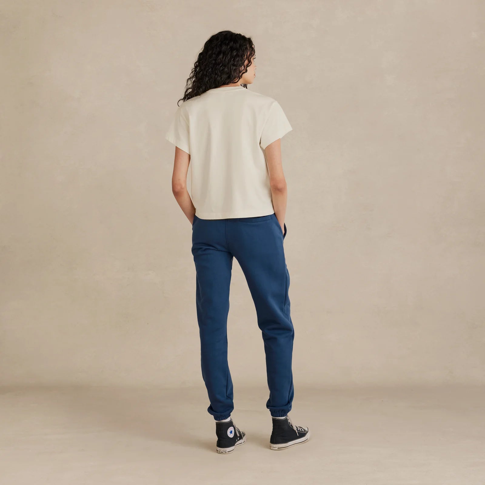 Woman wearing off-white Women’s Easy Fit Tee – relaxed fit, side view