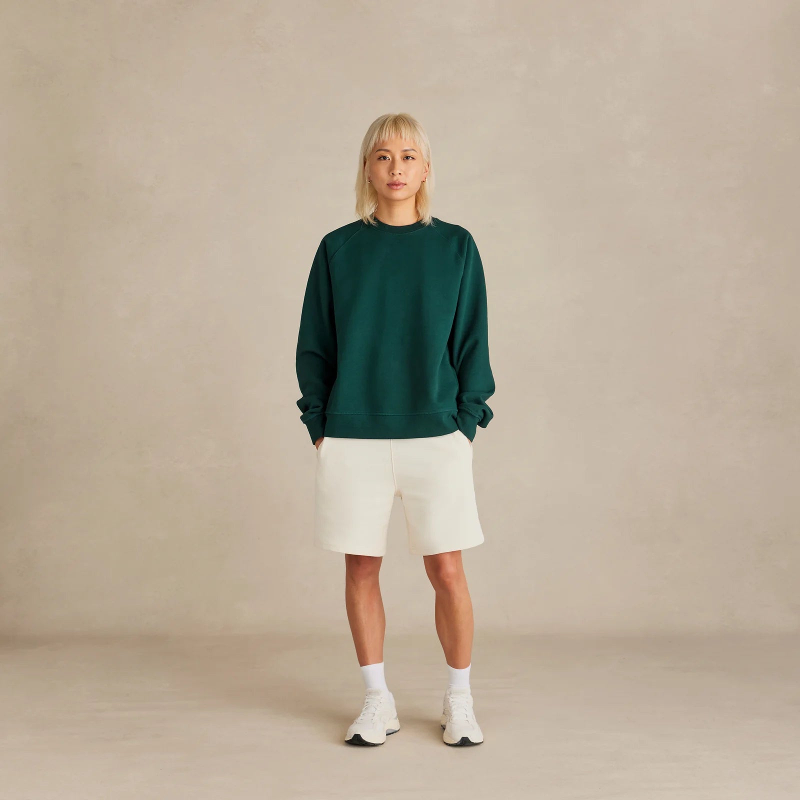 The Relaxed Crewneck green sweatshirt worn by female model