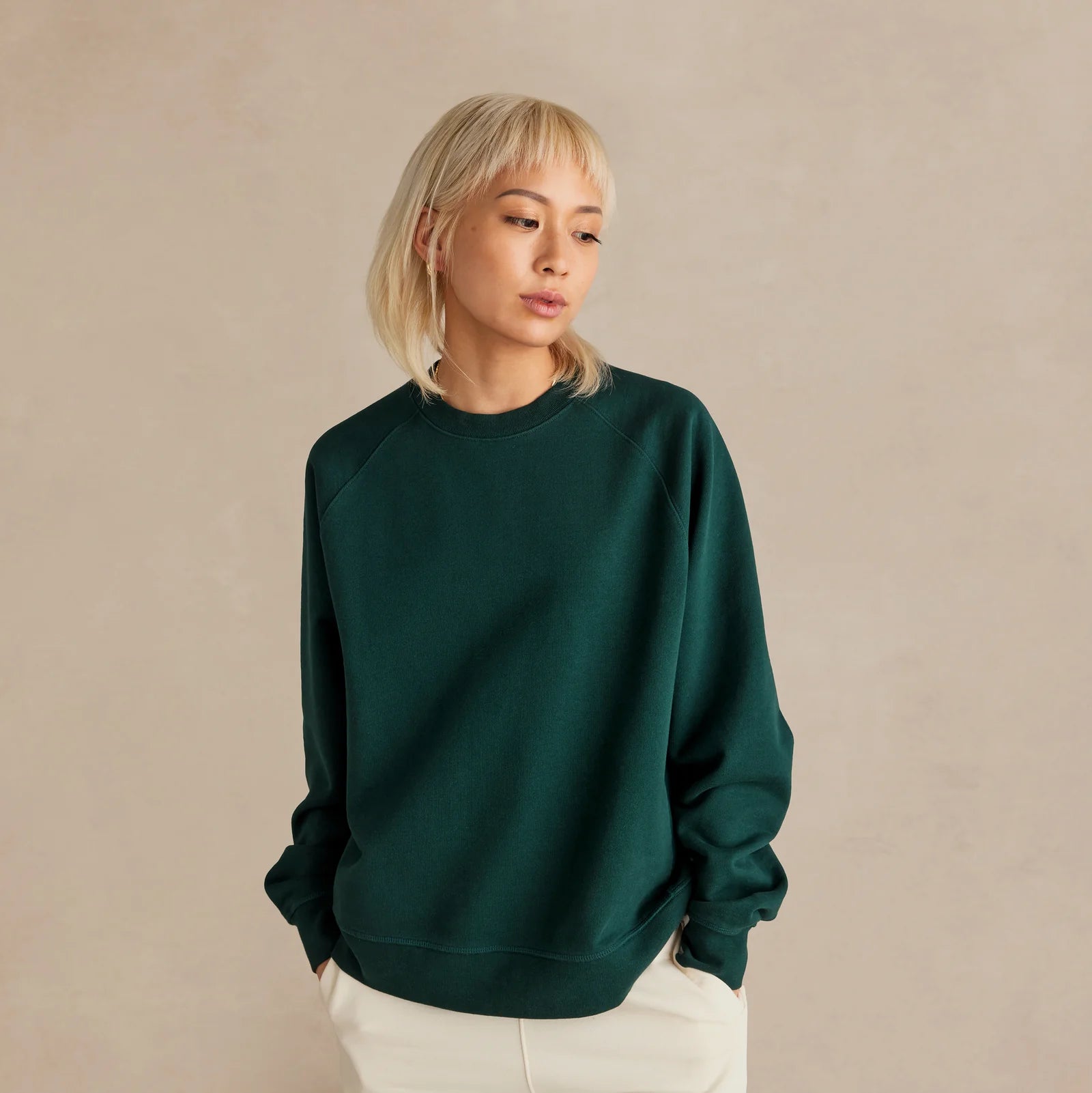 The Relaxed Crewneck green sweatshirt worn by female model