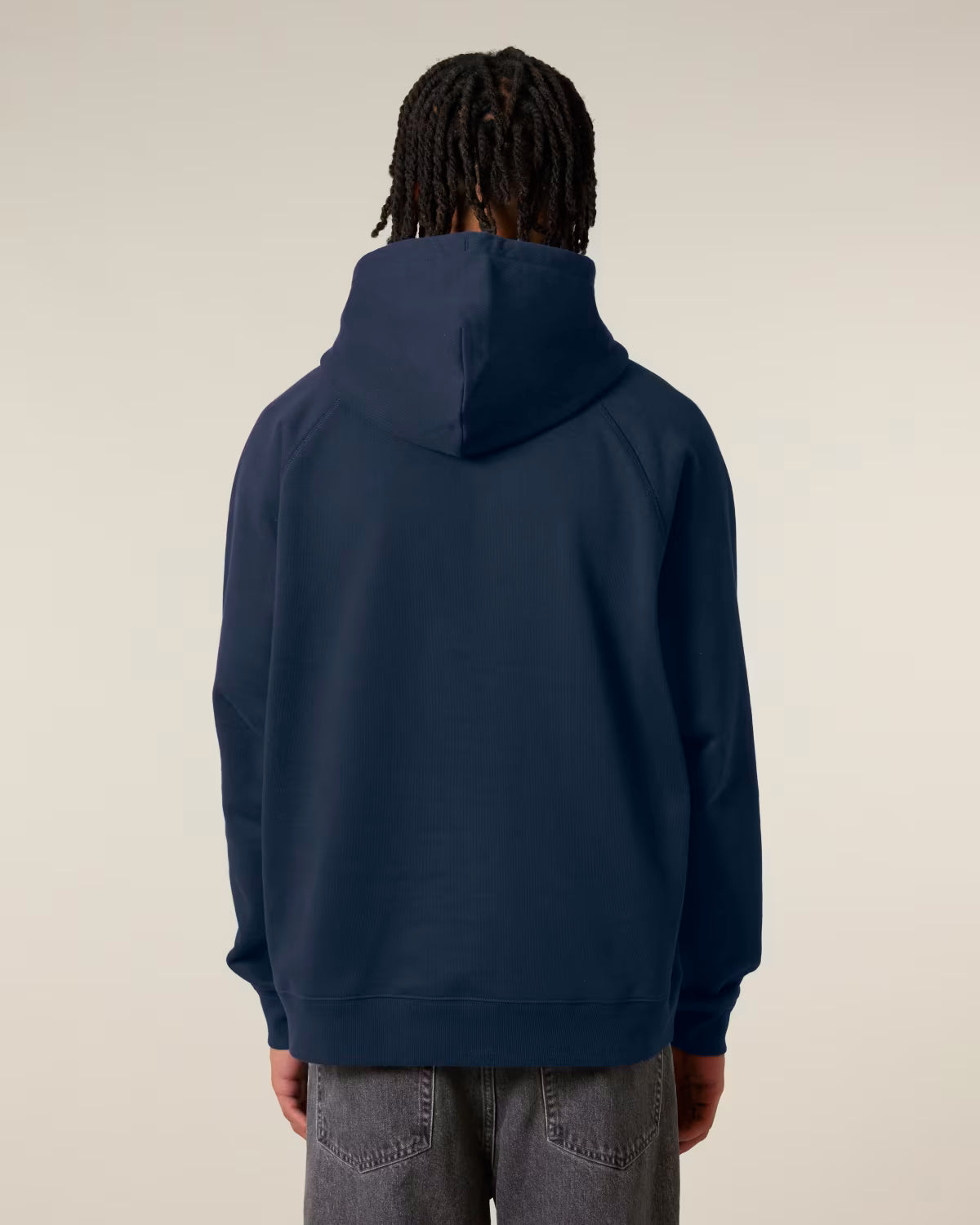 Back view of a male model wearing a navy cotton hoodie in studio