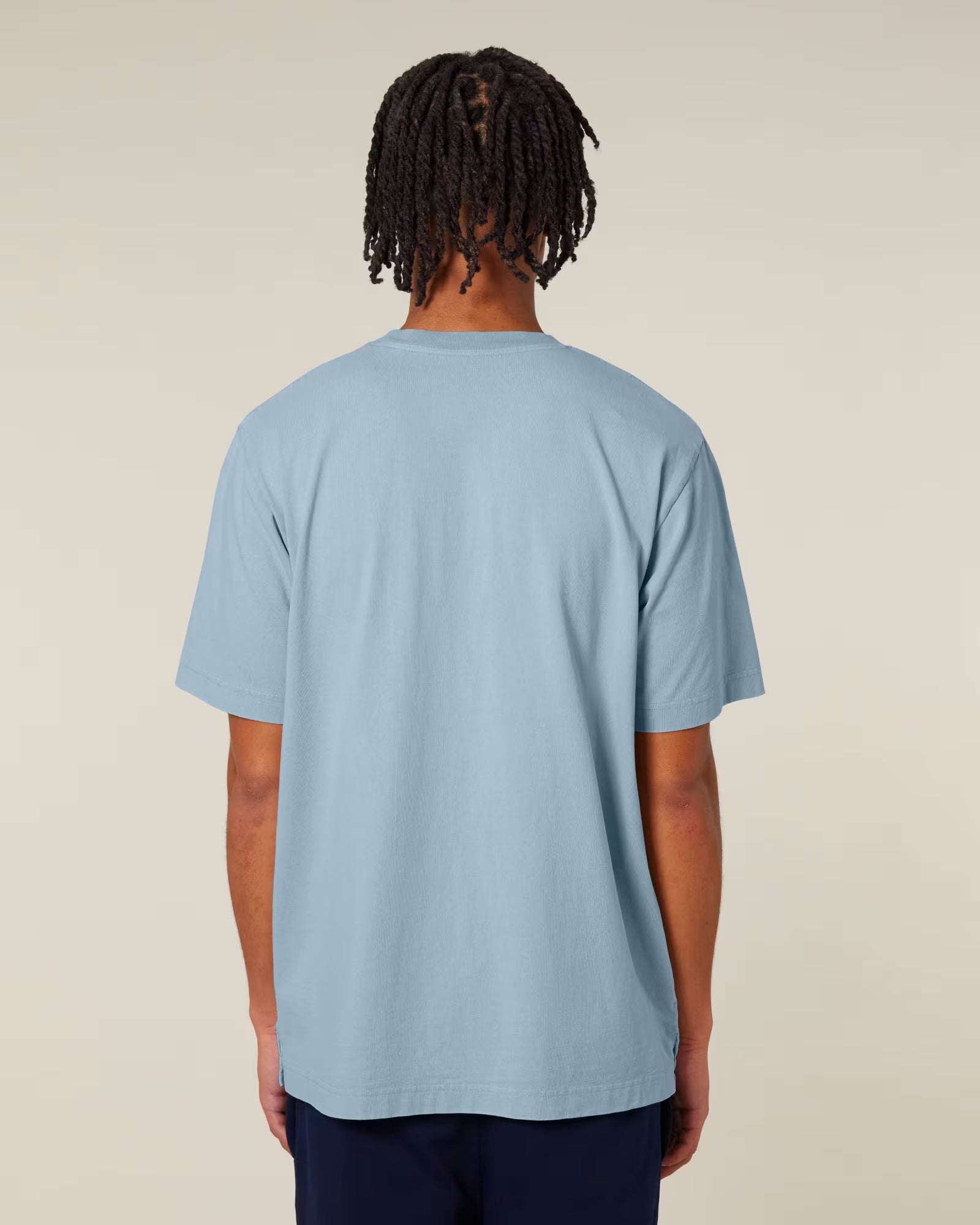 Back view of a male model wearing a light blue cotton t-shirt in studio