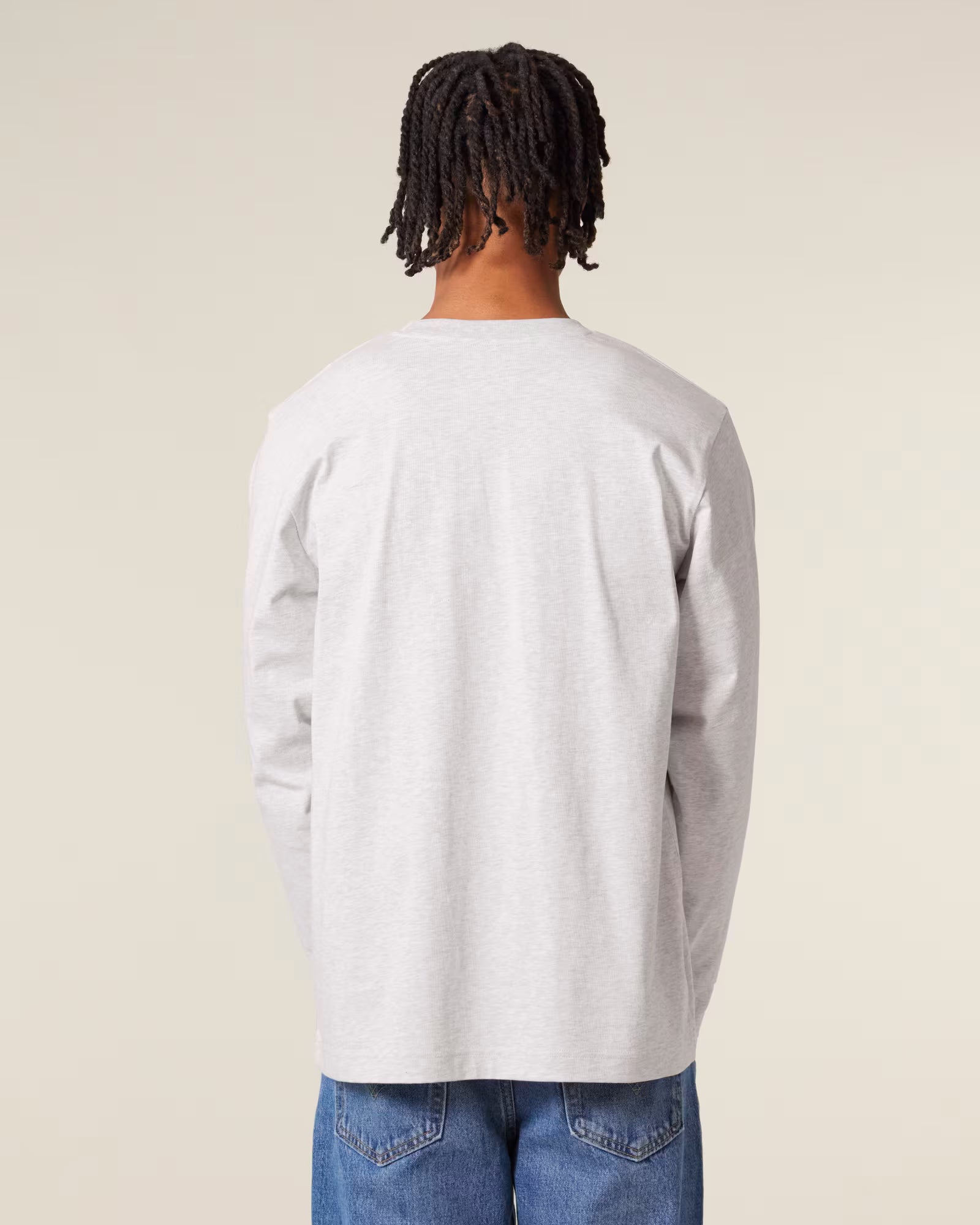 Back view of a male model wearing a white cotton long sleeve t-shirt in studio