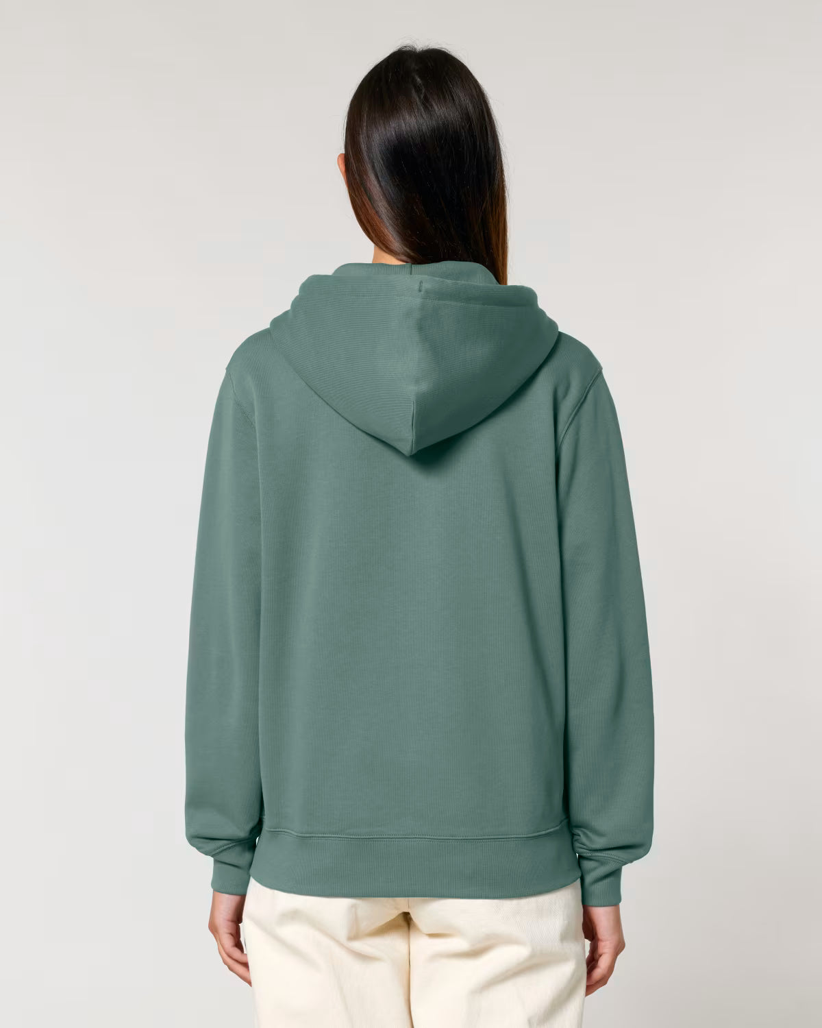Back view of a male model wearing an olive green cotton hoodie in studio