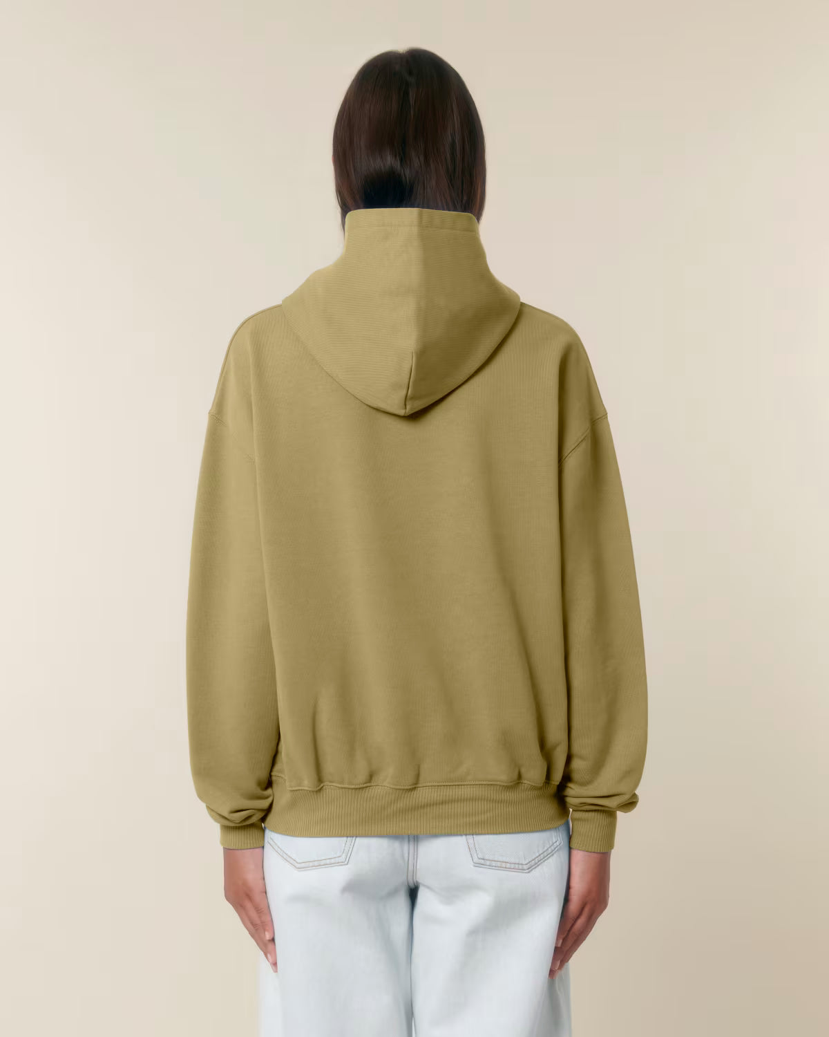 Back view of a male model wearing an olive green cotton hoodie in studio