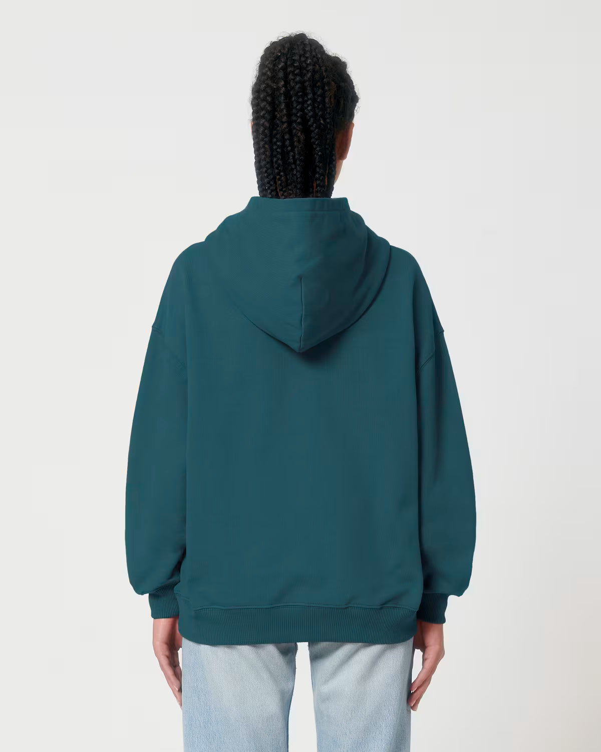 Back view of a male model wearing a teal cotton hoodie in studio
