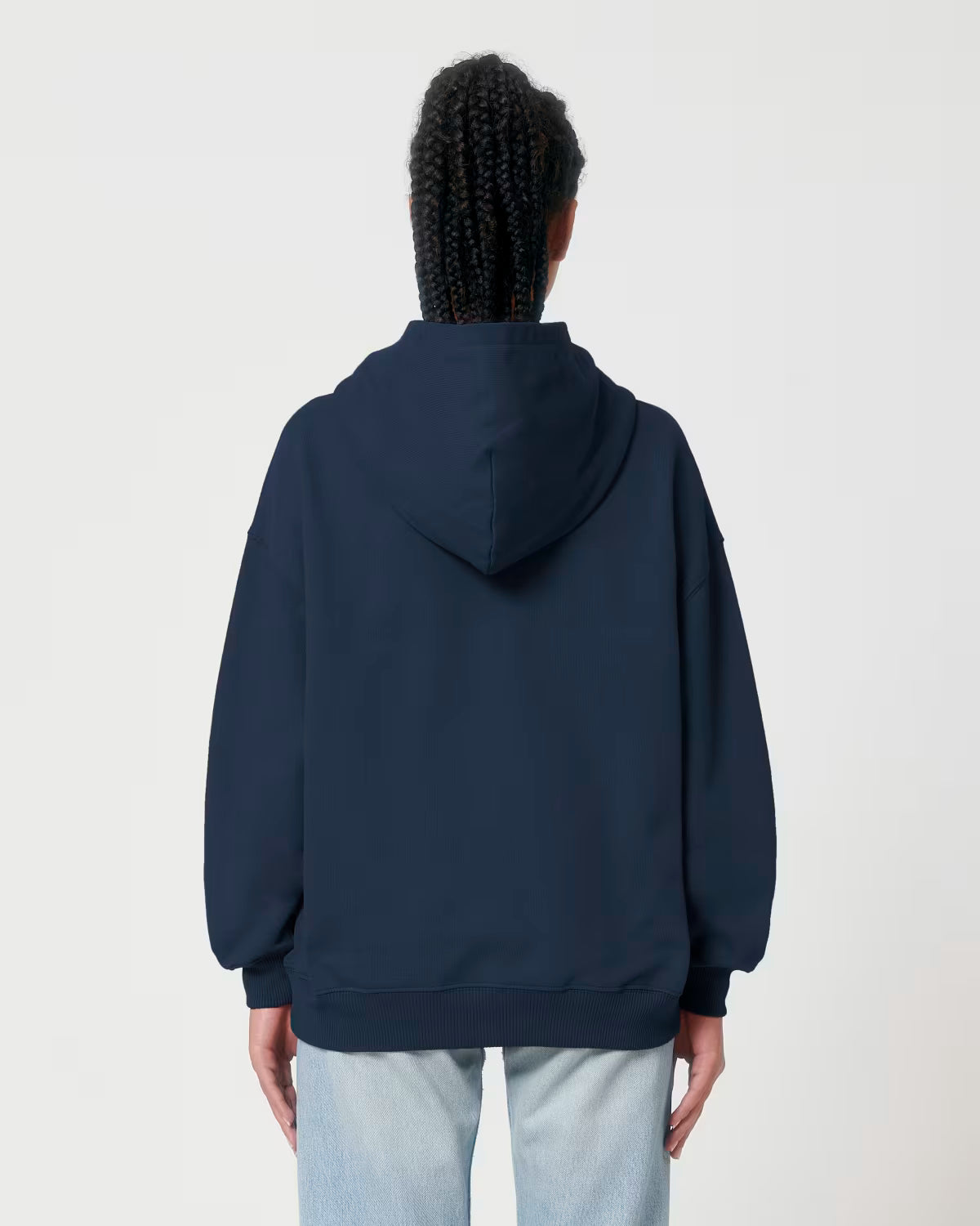 Back view of a male model wearing a navy cotton hoodie in studio