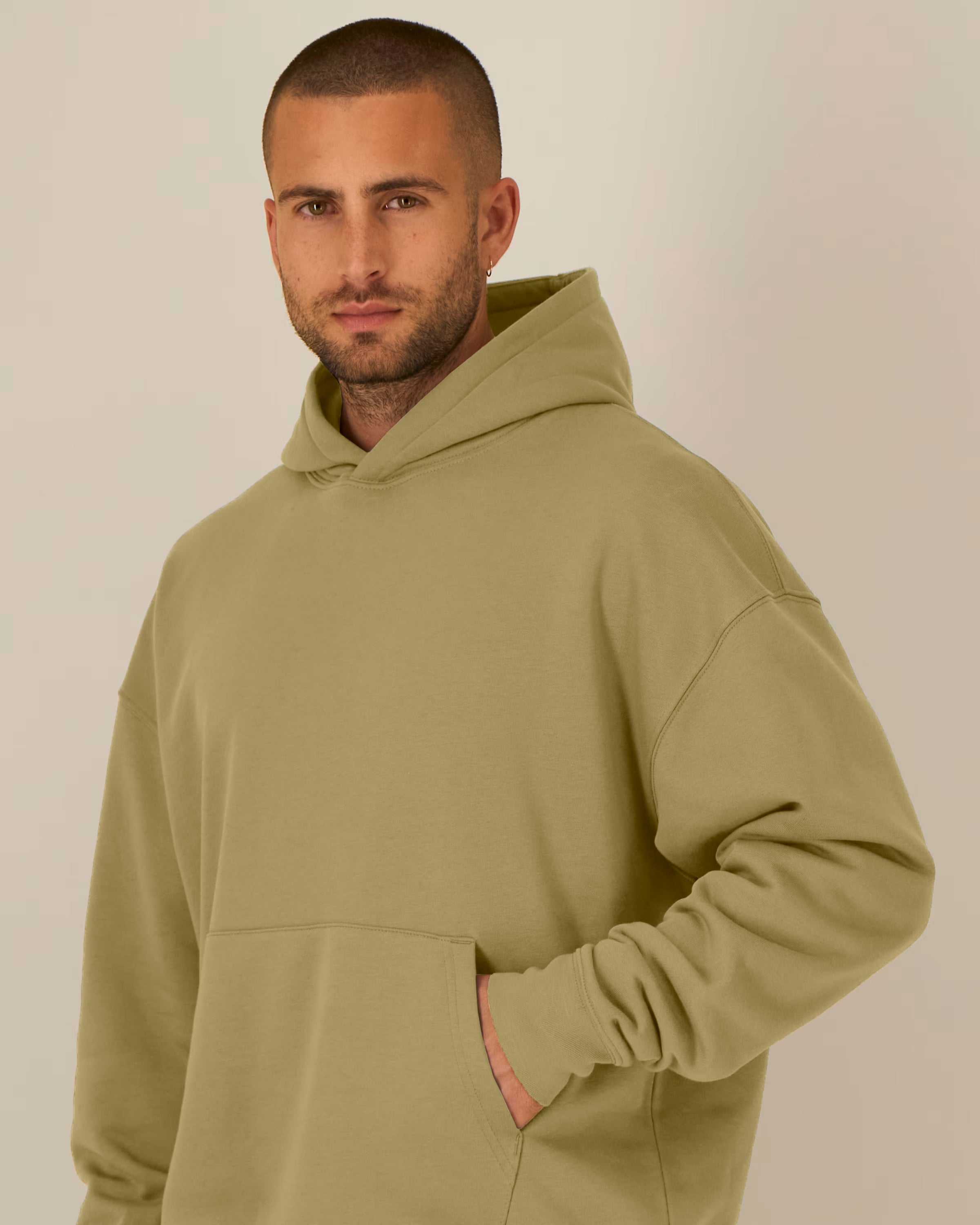 Man wearing Olive green unisex organic cotton hoodie made from midweight fleece