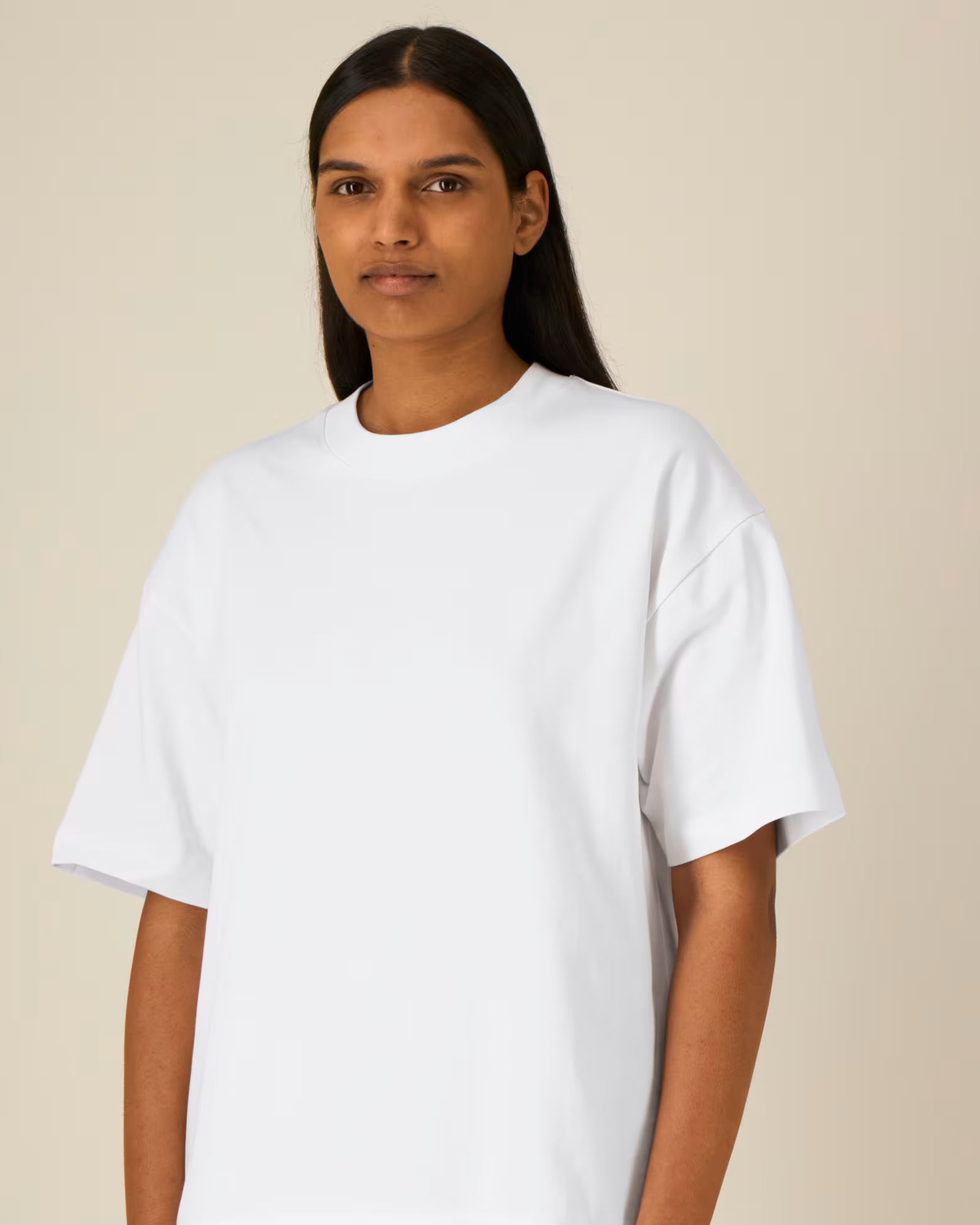 Front detail view of a female model wearing a white cotton t-shirt in studio