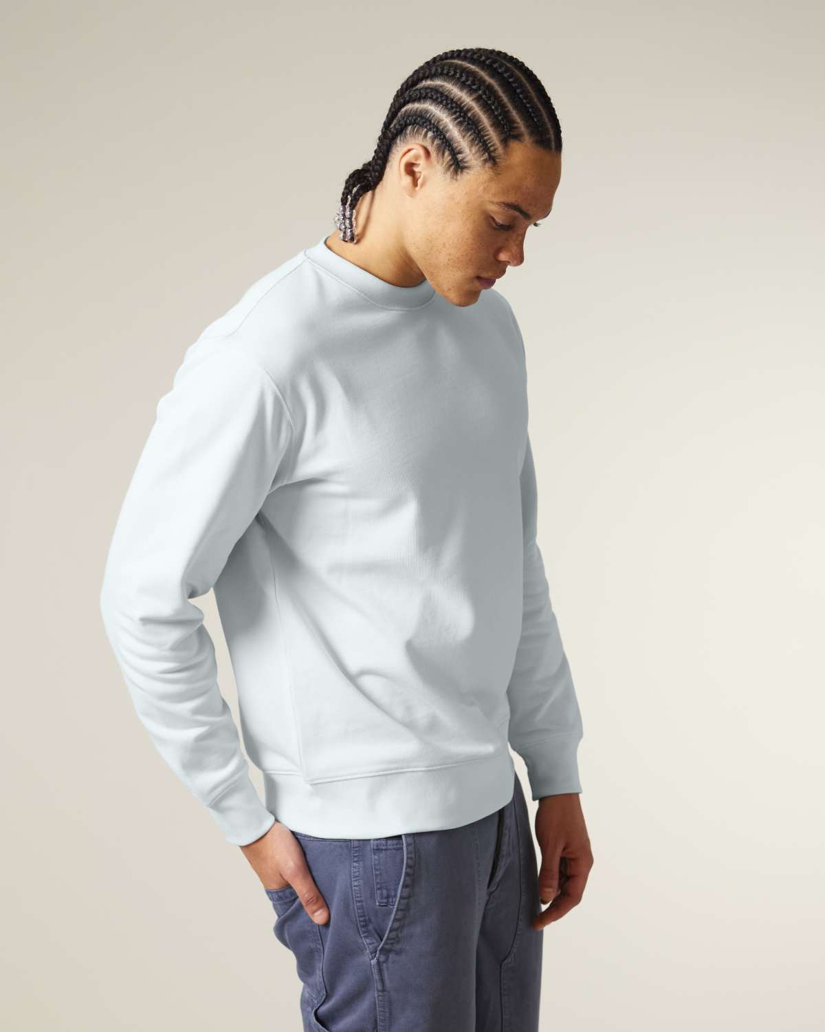 Person wearing a light gray unisex cotton hoodie isolated on white background