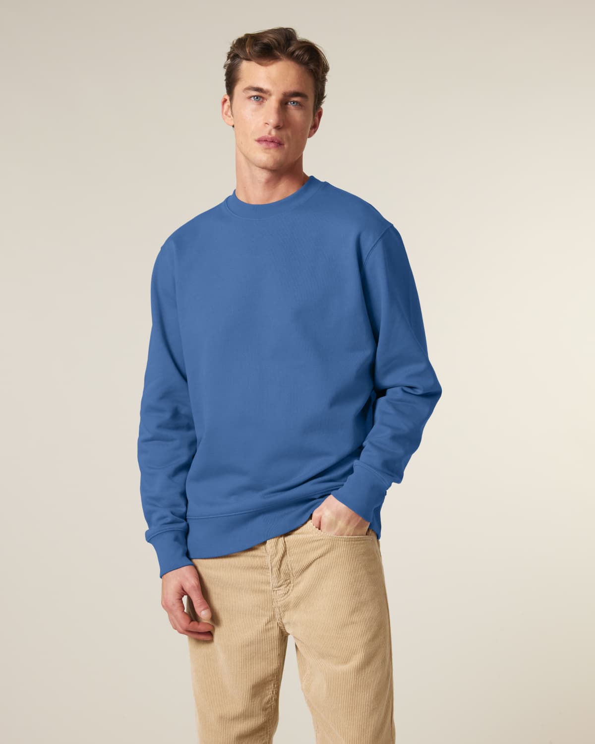 Man wearing a blue unisex cotton hoodie isolated on white background