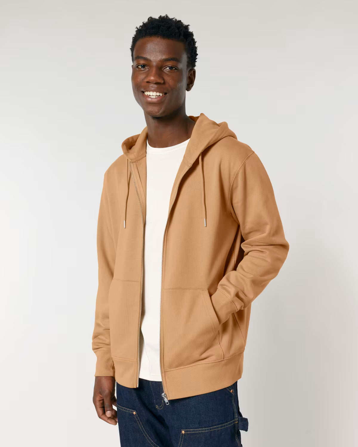 Front view of a male model wearing a mustard yellow cotton hoodie in studio