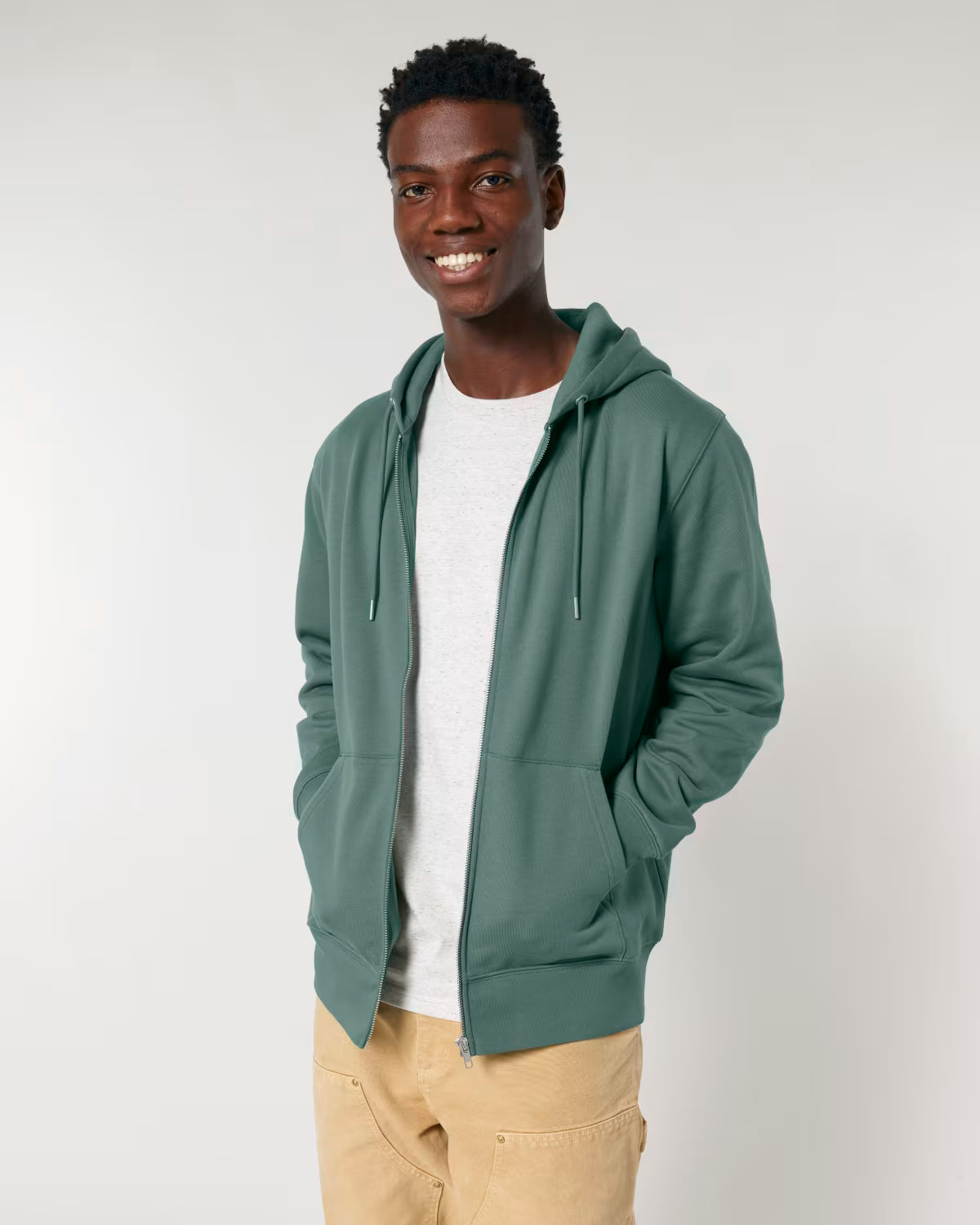 Front view of a male model wearing an green cotton hoodie in studio