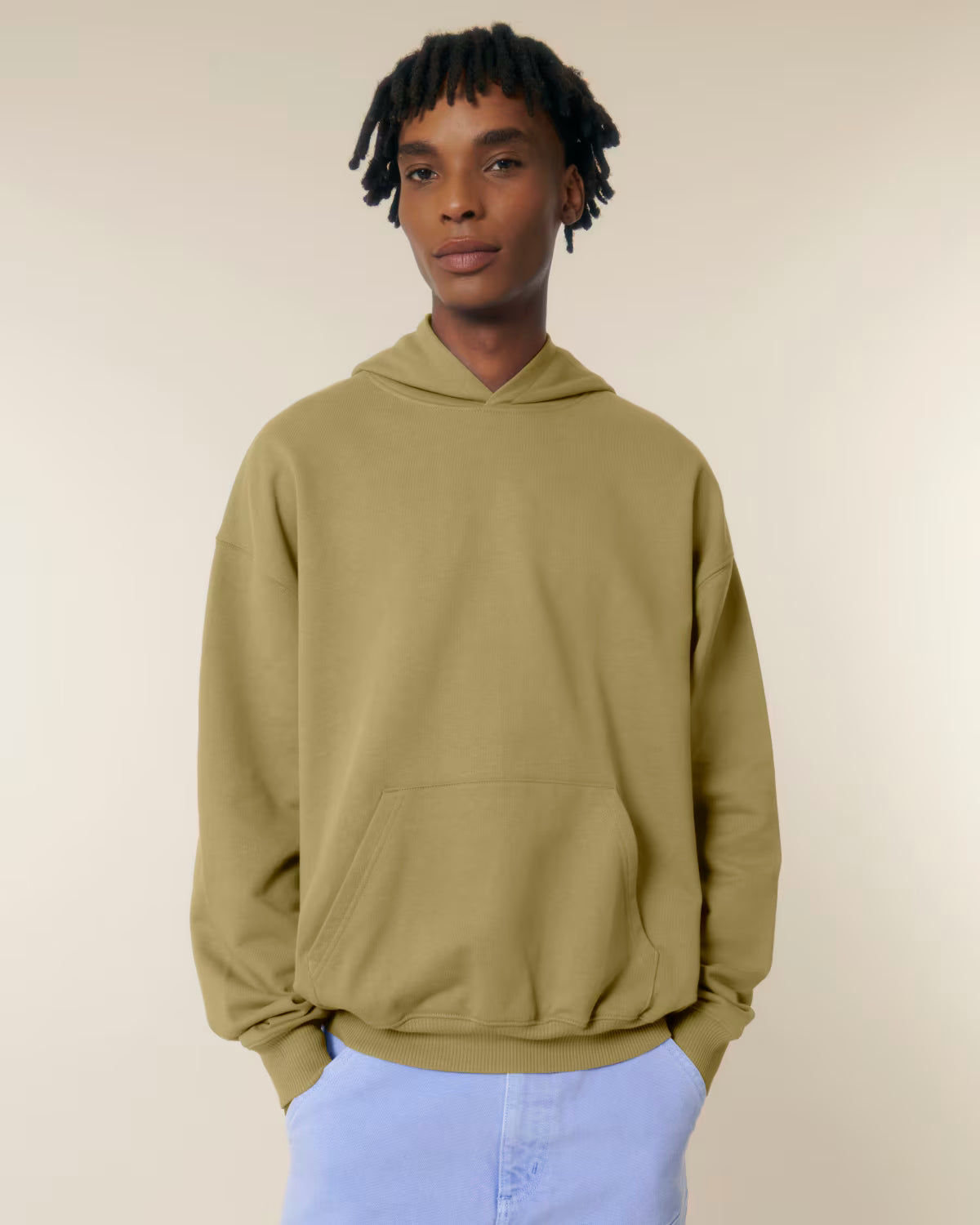 Front view of a male model wearing an olive green cotton hoodie in studio