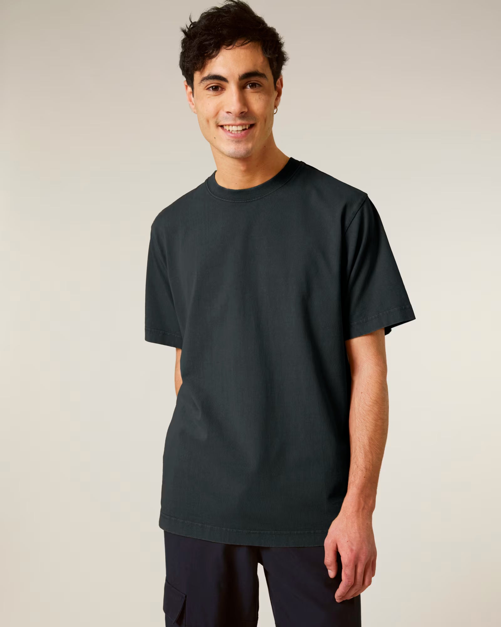 Front view of a man wearing a dark green cotton t-shirt in studio