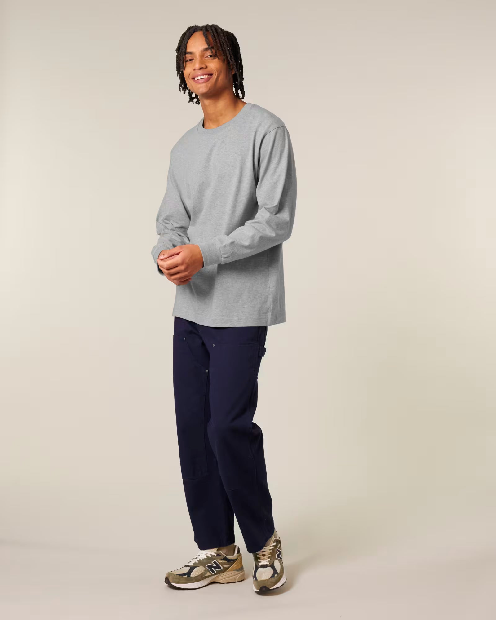Front view of a male model wearing a light grey cotton long sleeve t-shirt in studio