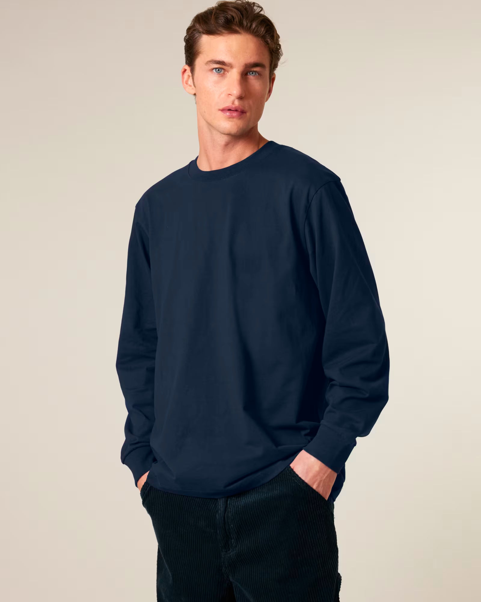 Front view of a male model wearing a navy cotton long sleeve t-shirt in studio