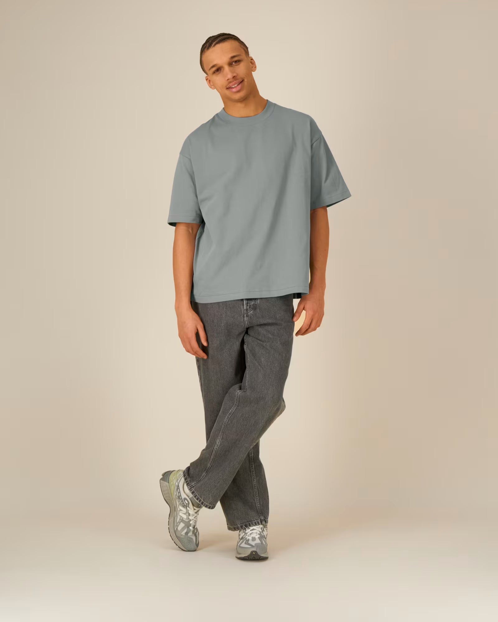 Full body front view of a model wearing a grey cotton t-shirt in studio