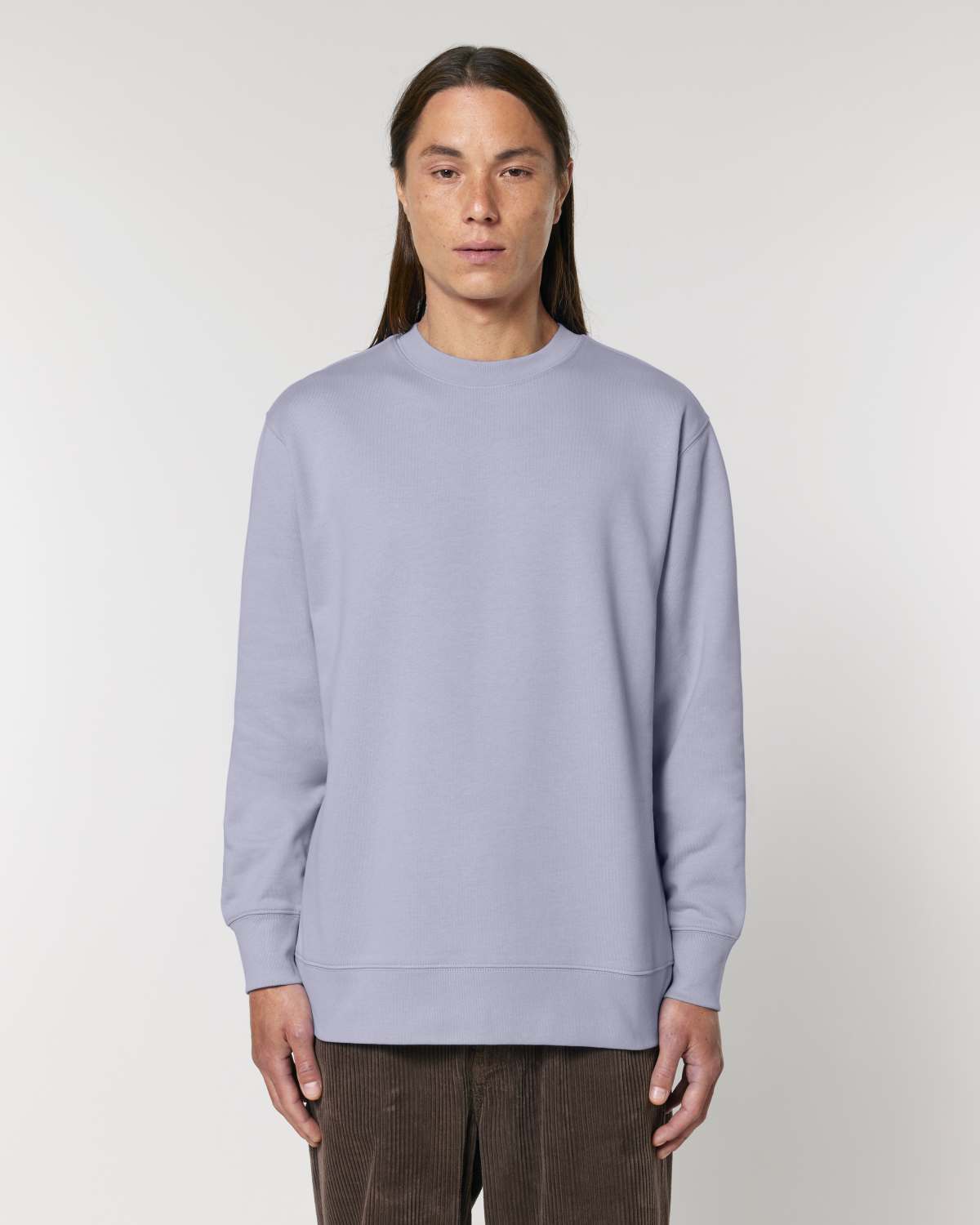 Person wearing a light blue unisex cotton sweatshirt against a plain background