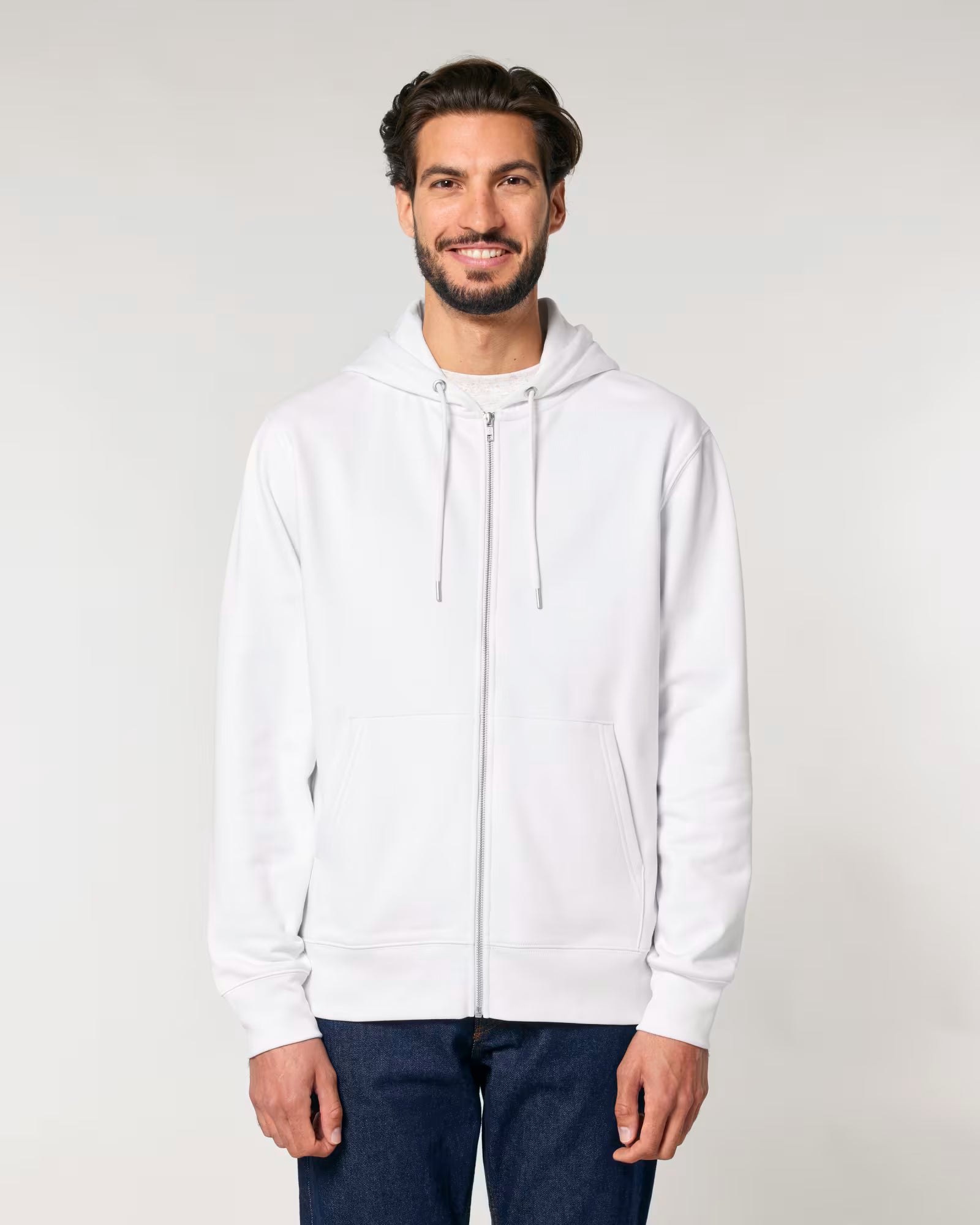 Man wearing a white cotton hoodie against a plain background