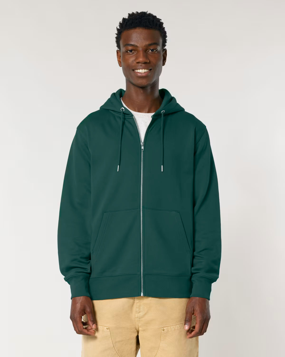 Front view of a male model wearing an  green cotton hoodie in studio