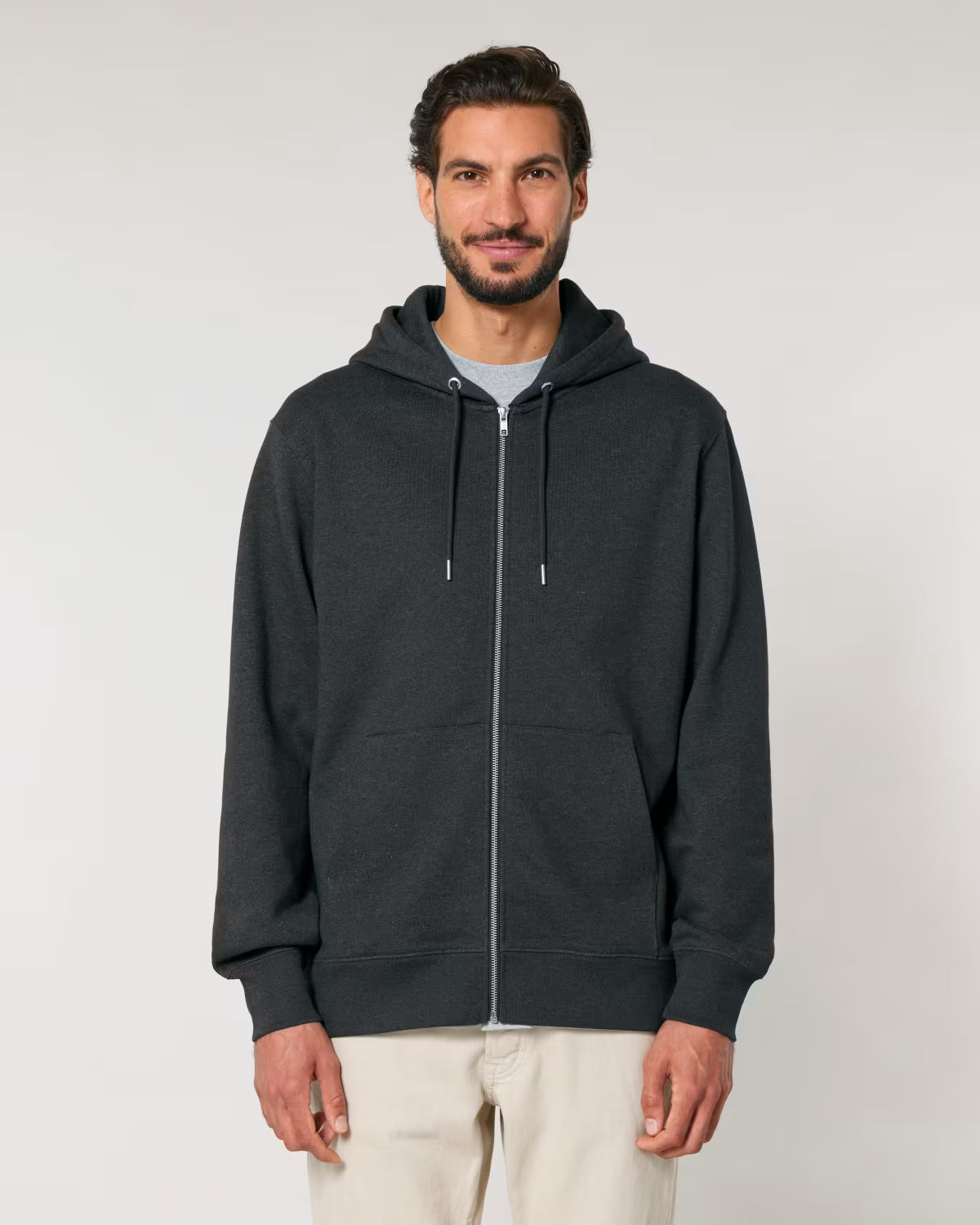 Front view of a male model wearing a black cotton hoodie in studio