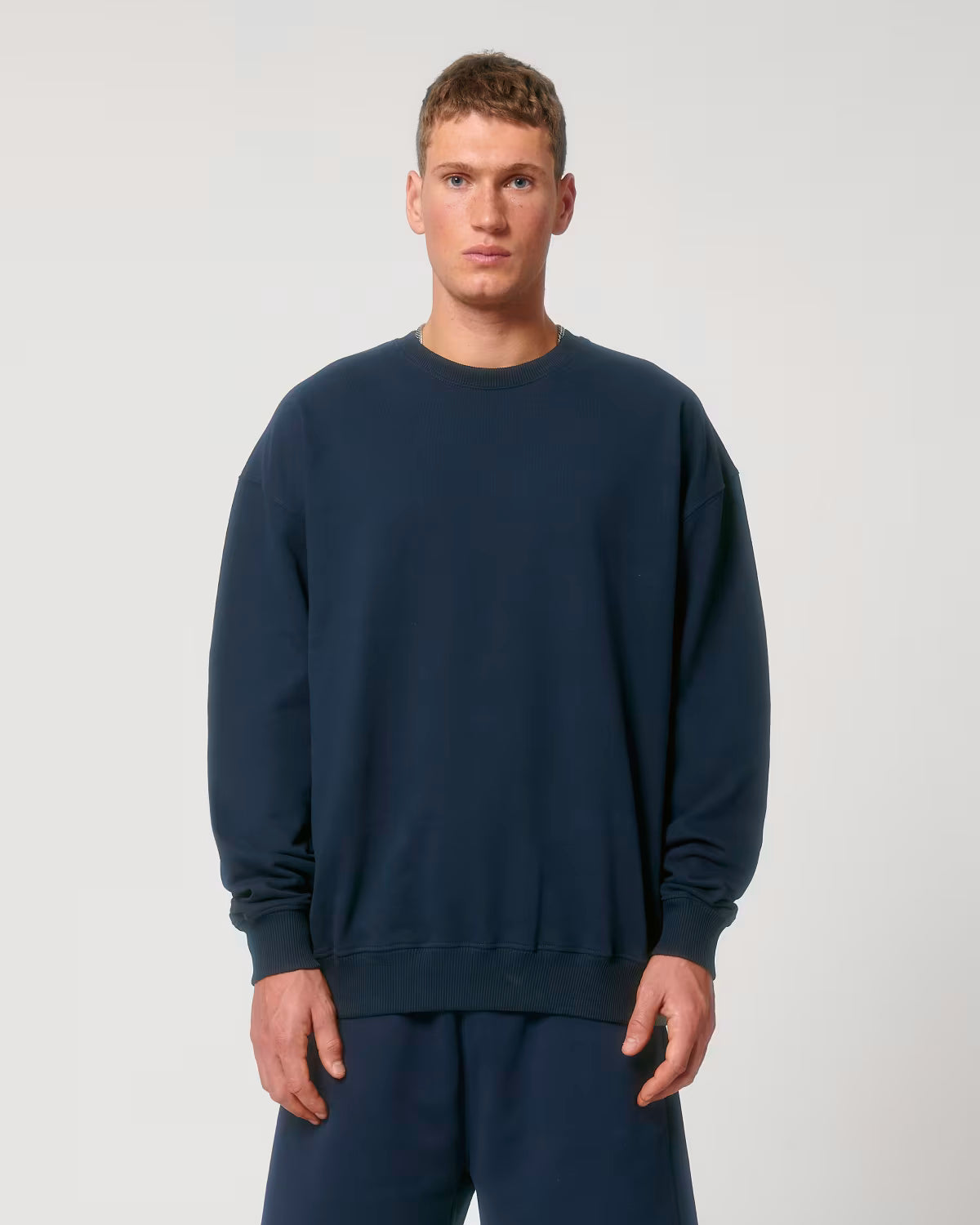 Front view of a male model wearing a navy cotton hoodie in studio