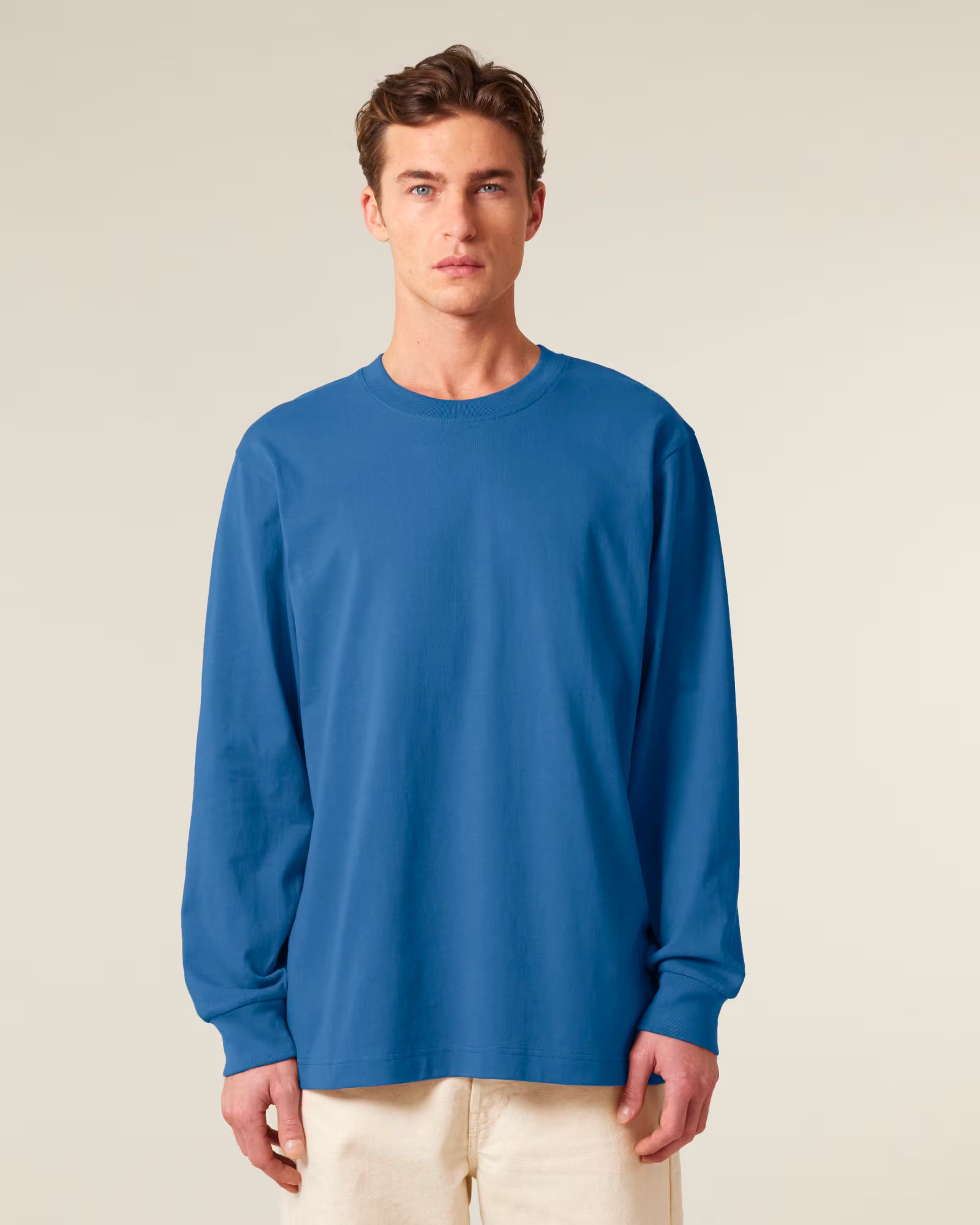 Front view of a male model wearing a blue cotton long sleeve t-shirt in studio