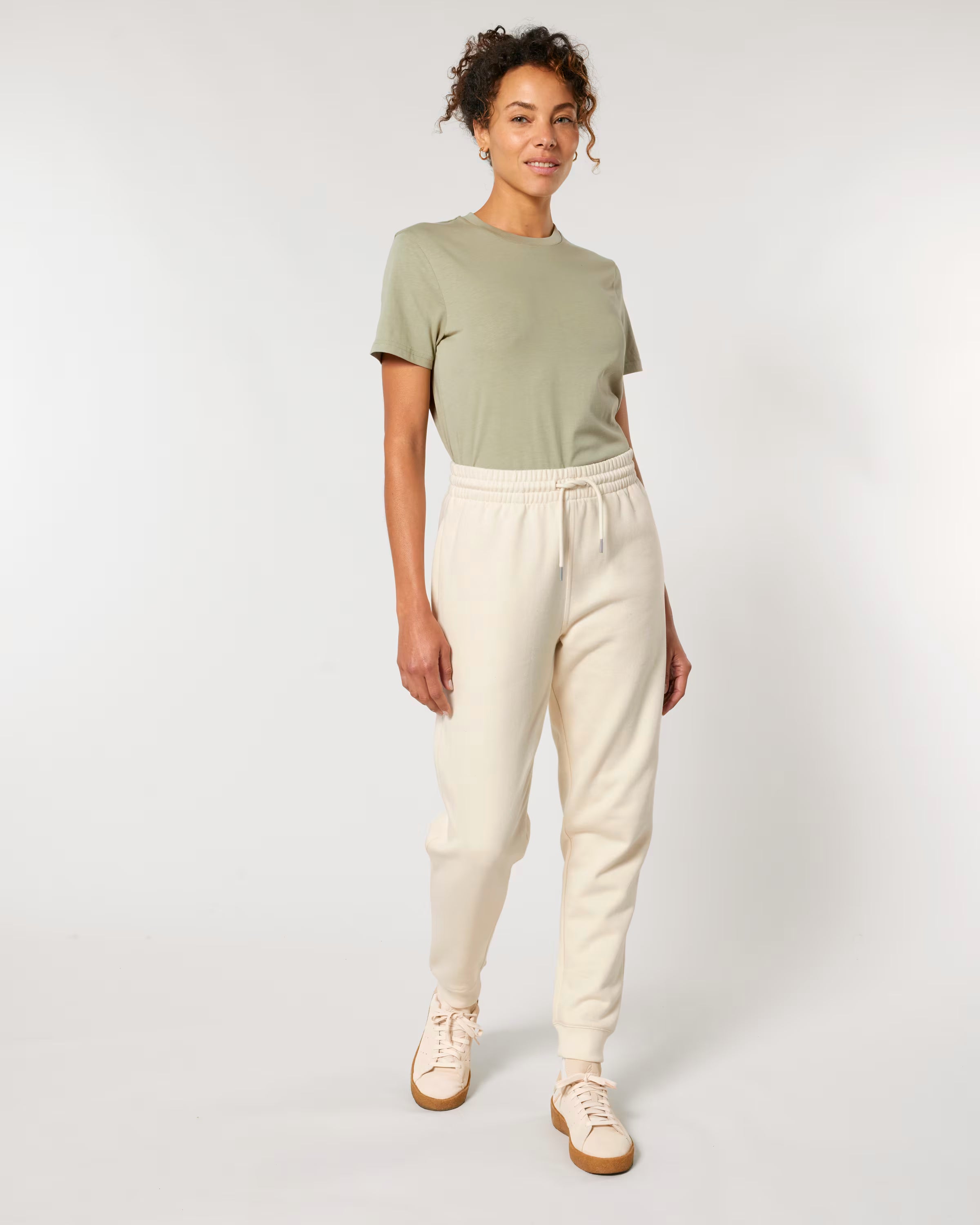 men’s off-white jogger pants on model, sustainable cotton merch apparel