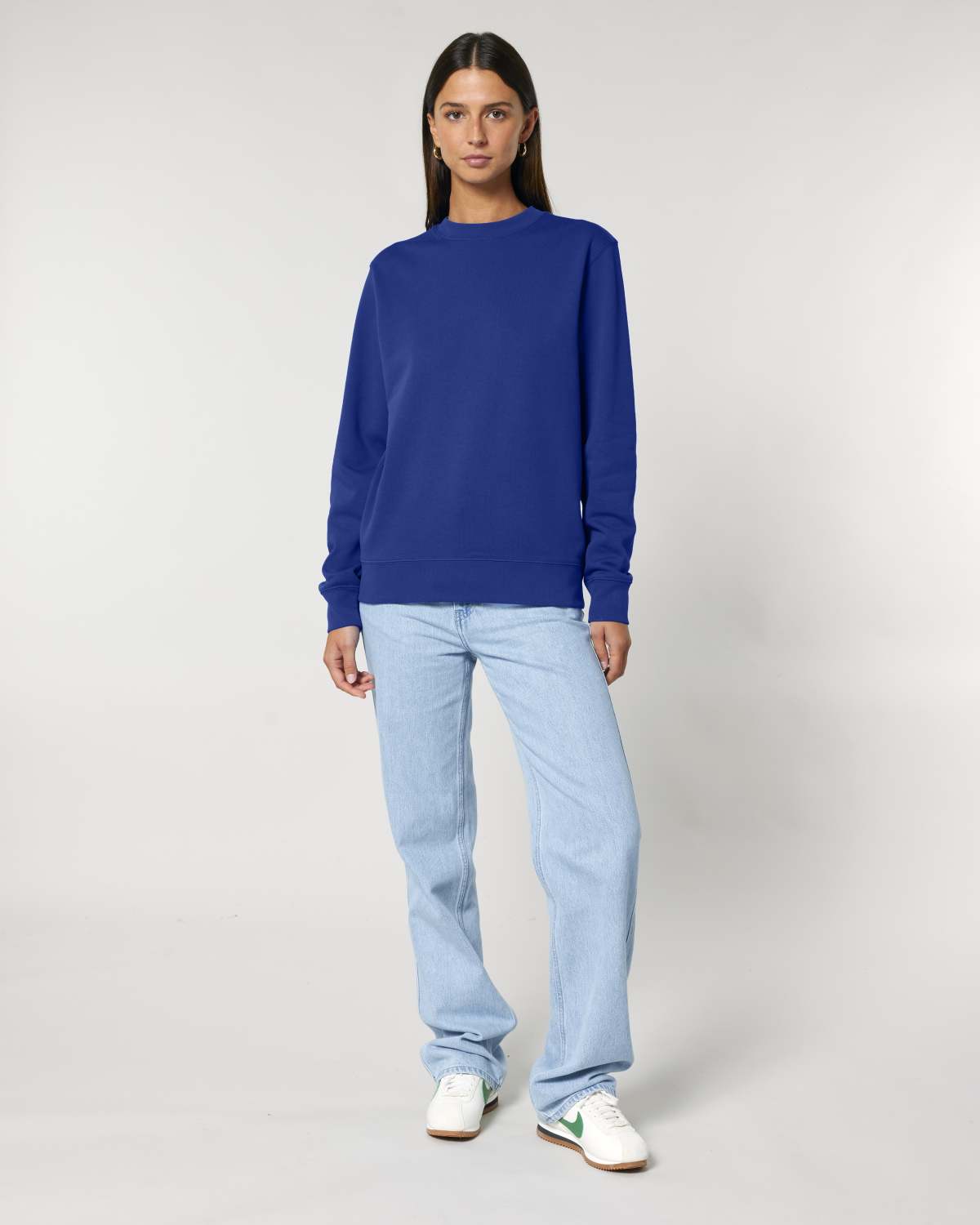 Person wearing a blue unisex cotton hoodie isolated on white background