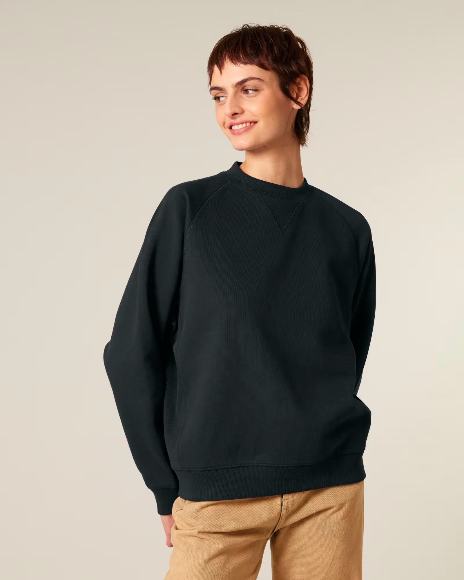 Front view of a male model wearing a black cotton sweatshirt in studio