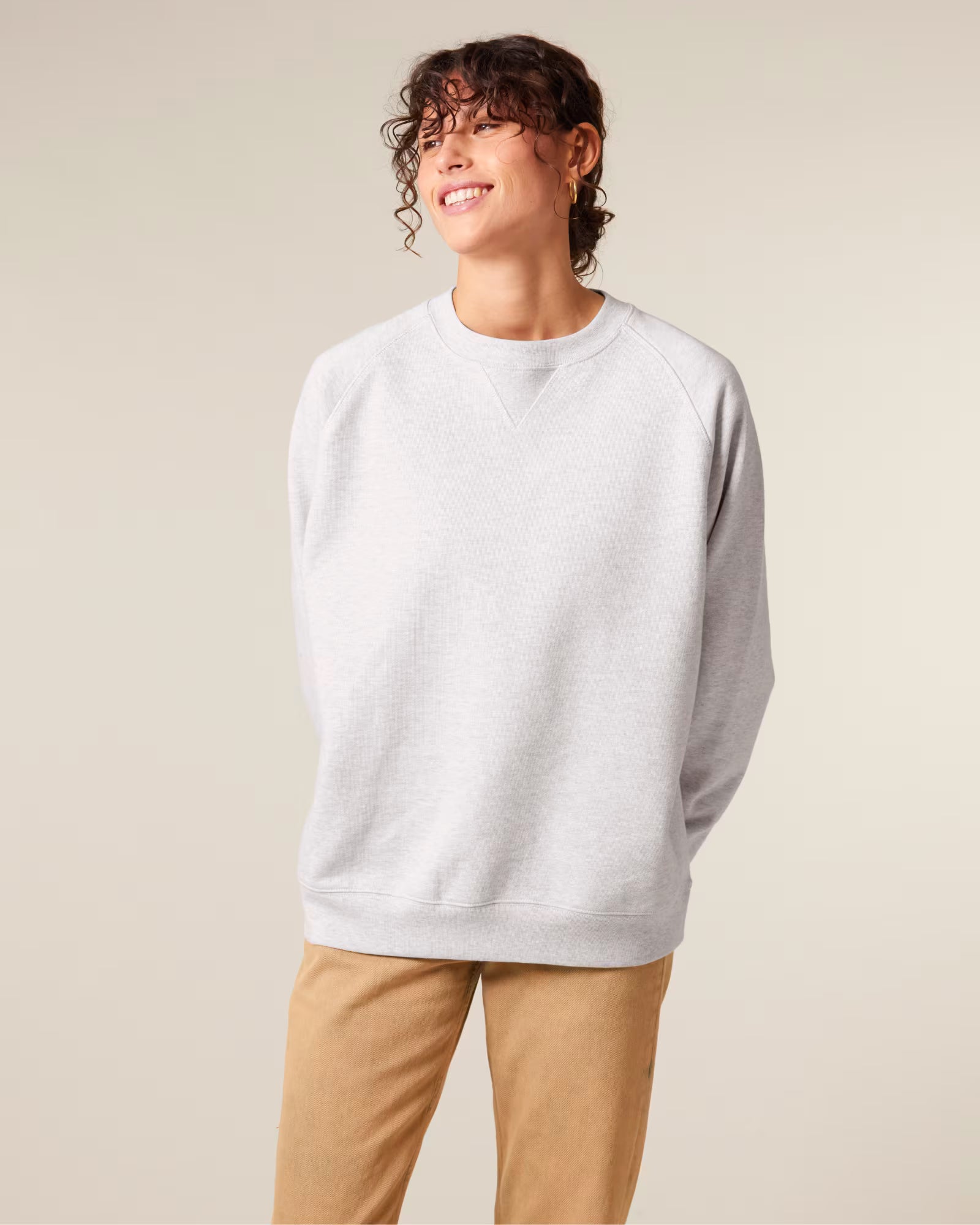 Front view of a male model wearing a white cotton sweatshirt in studio