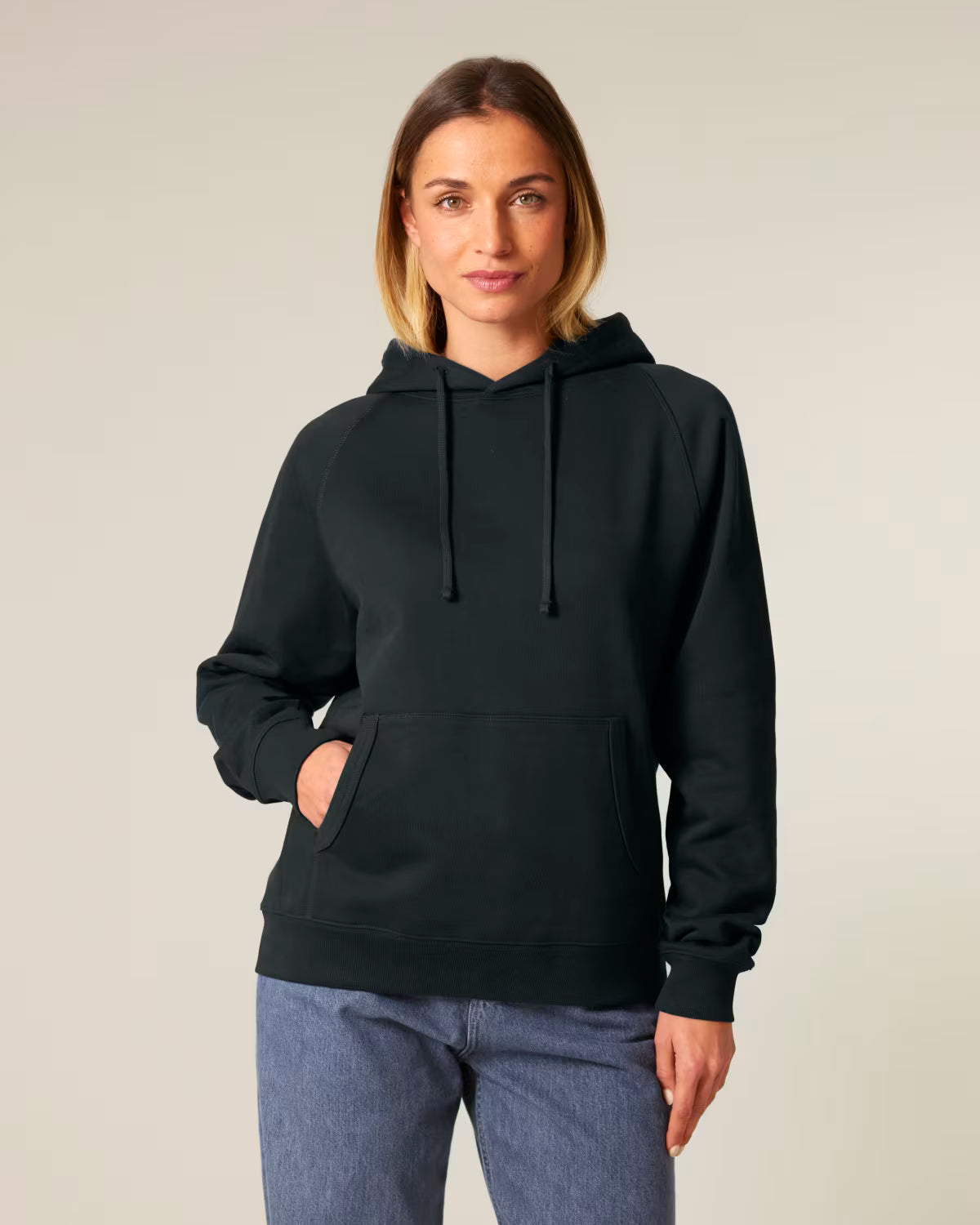 Front view of a female model wearing a black cotton hoodie in studio