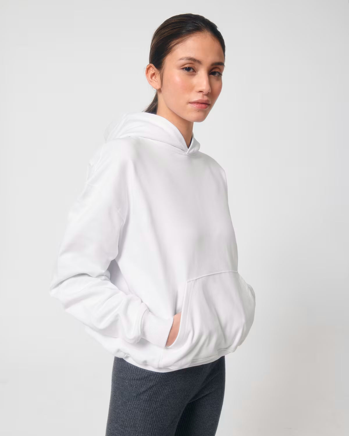 Front view of a male model wearing a white cotton hoodie in studio