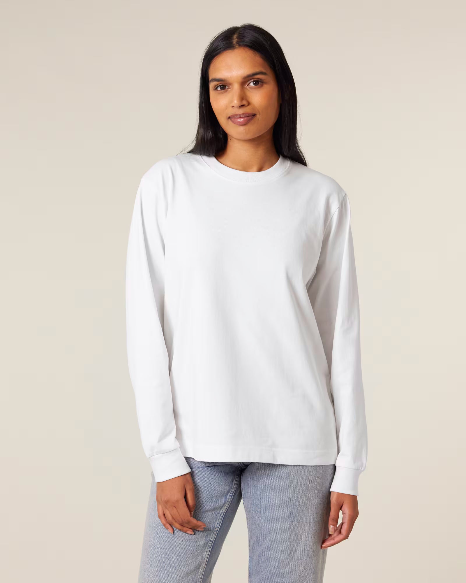 Front view of a male model wearing a white cotton long sleeve t-shirt in studio