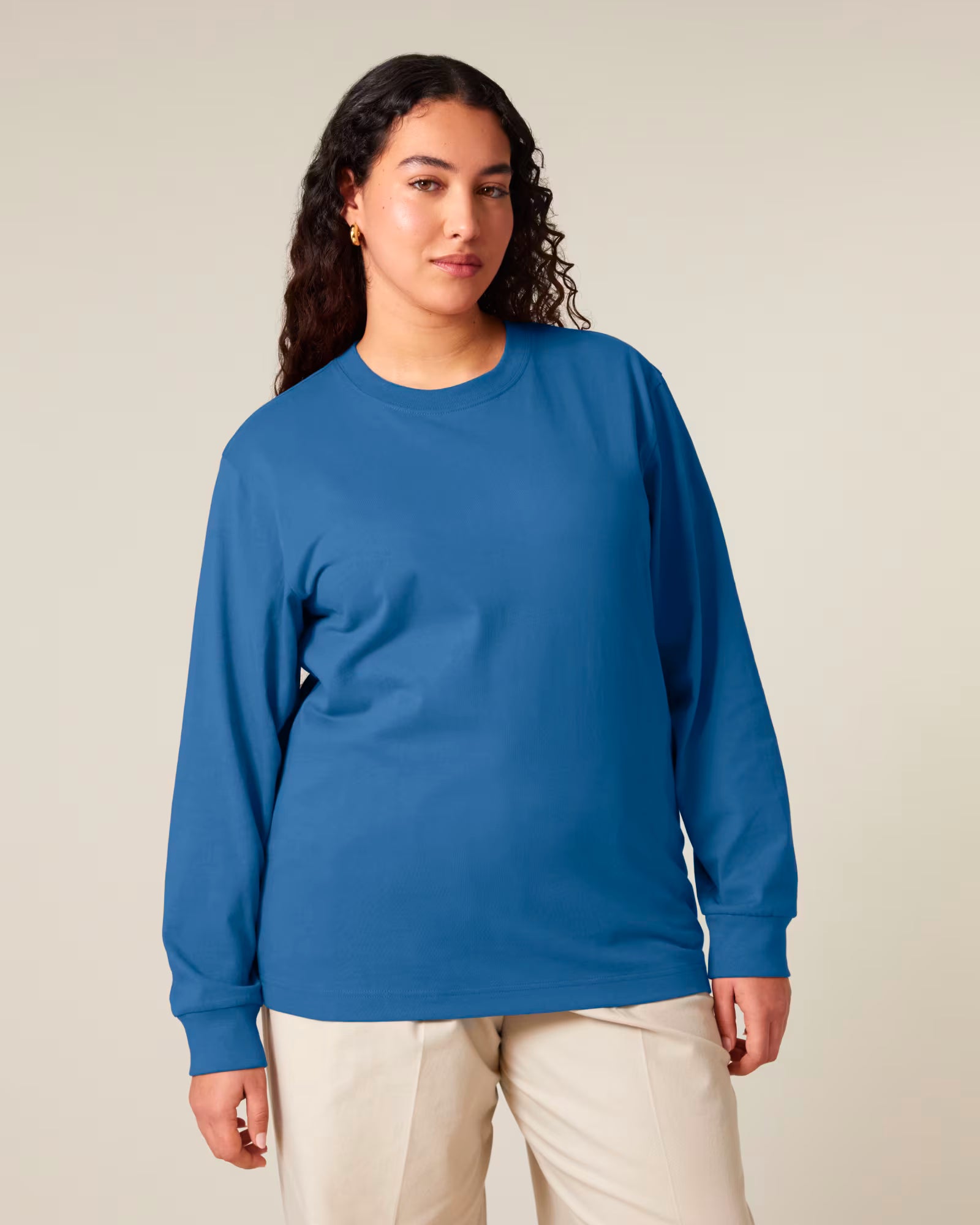 Front view of a female model wearing a blue cotton long sleeve t-shirt in studio