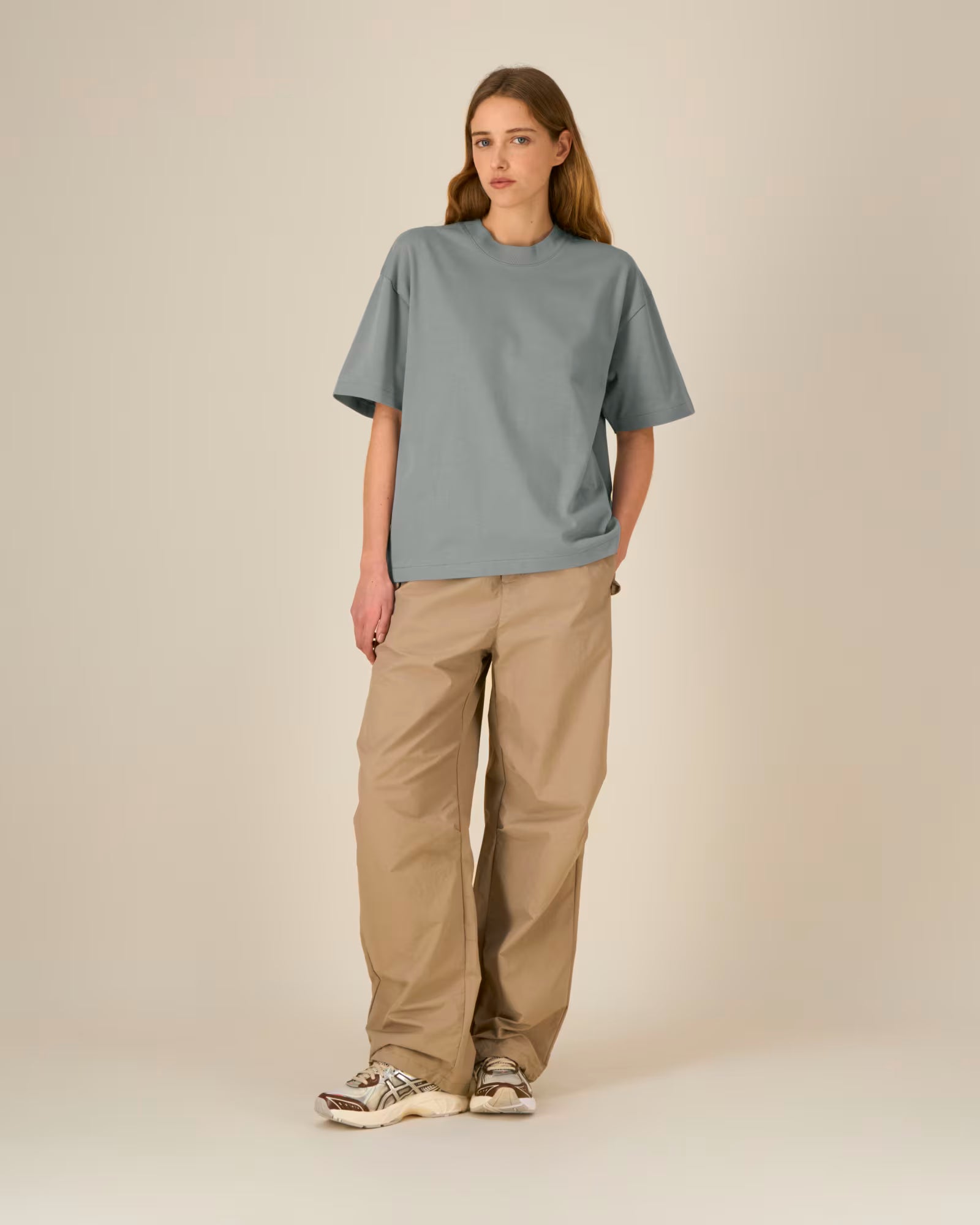 Full body front view of a female model wearing a light blue cotton t-shirt in studio