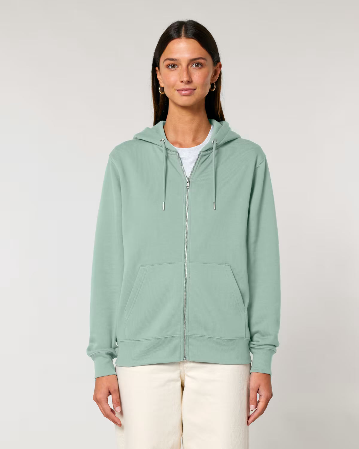 Woman wearing unisex cotton a light green hoodie on a plain background