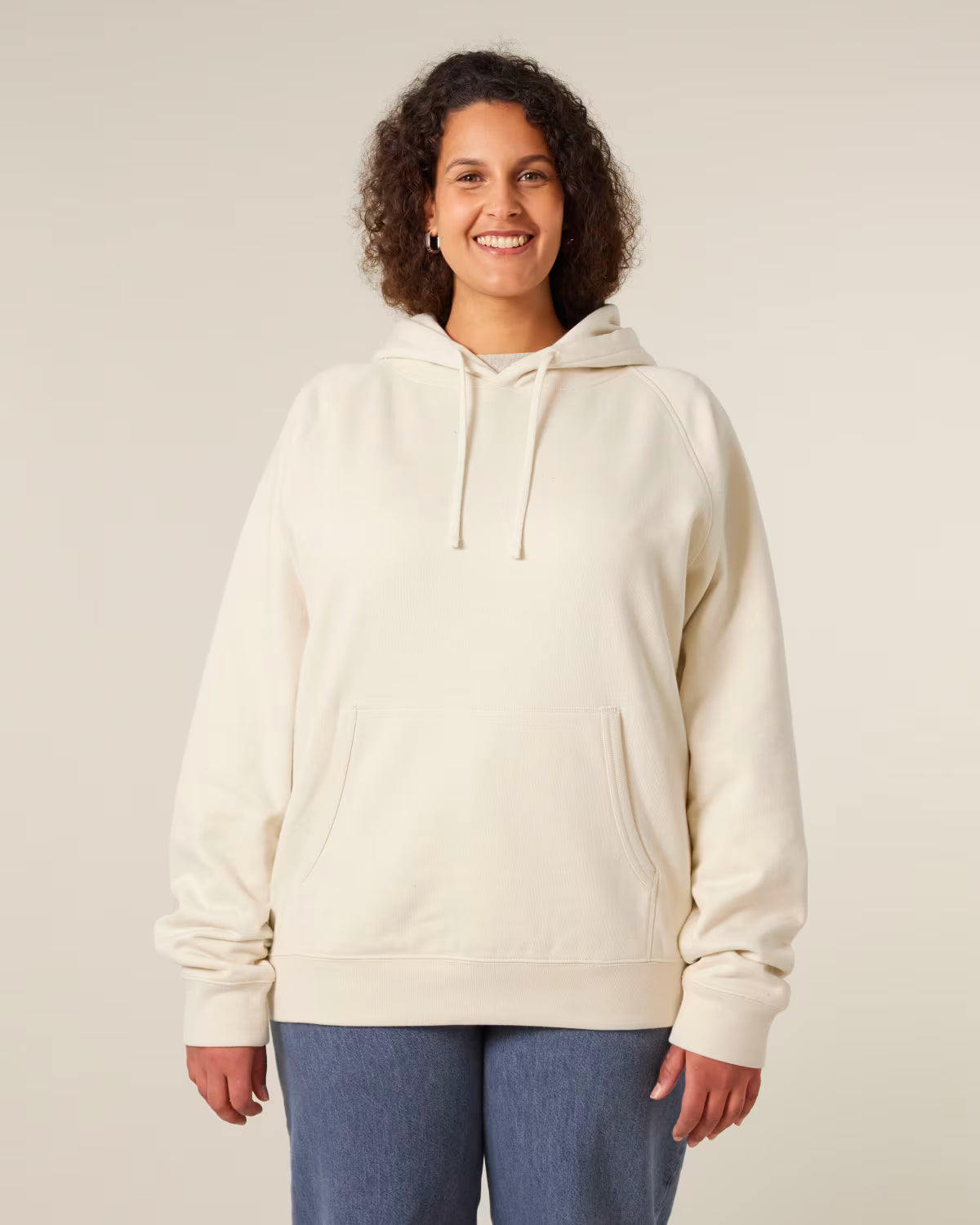 Front view of a female model wearing a beige orange cotton hoodie in studio