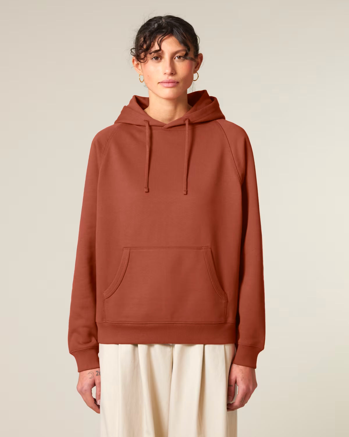 Back view of a rust orange unisex cotton hoodie isolated on white background