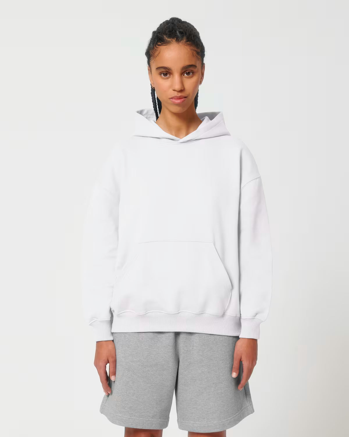 Front view of a female model wearing a white cotton hoodie in studio