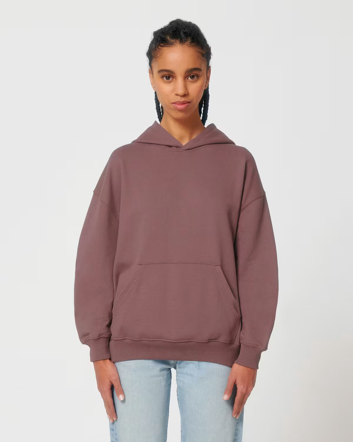Front view of a female model wearing a dusty rose cotton hoodie in studio
