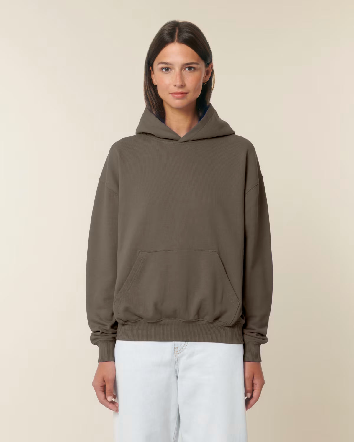 Front view of a female model wearing a brown cotton hoodie in studio