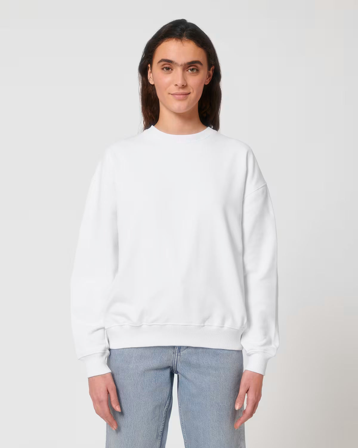 Front view of a female model wearing a white cotton hoodie in studio
