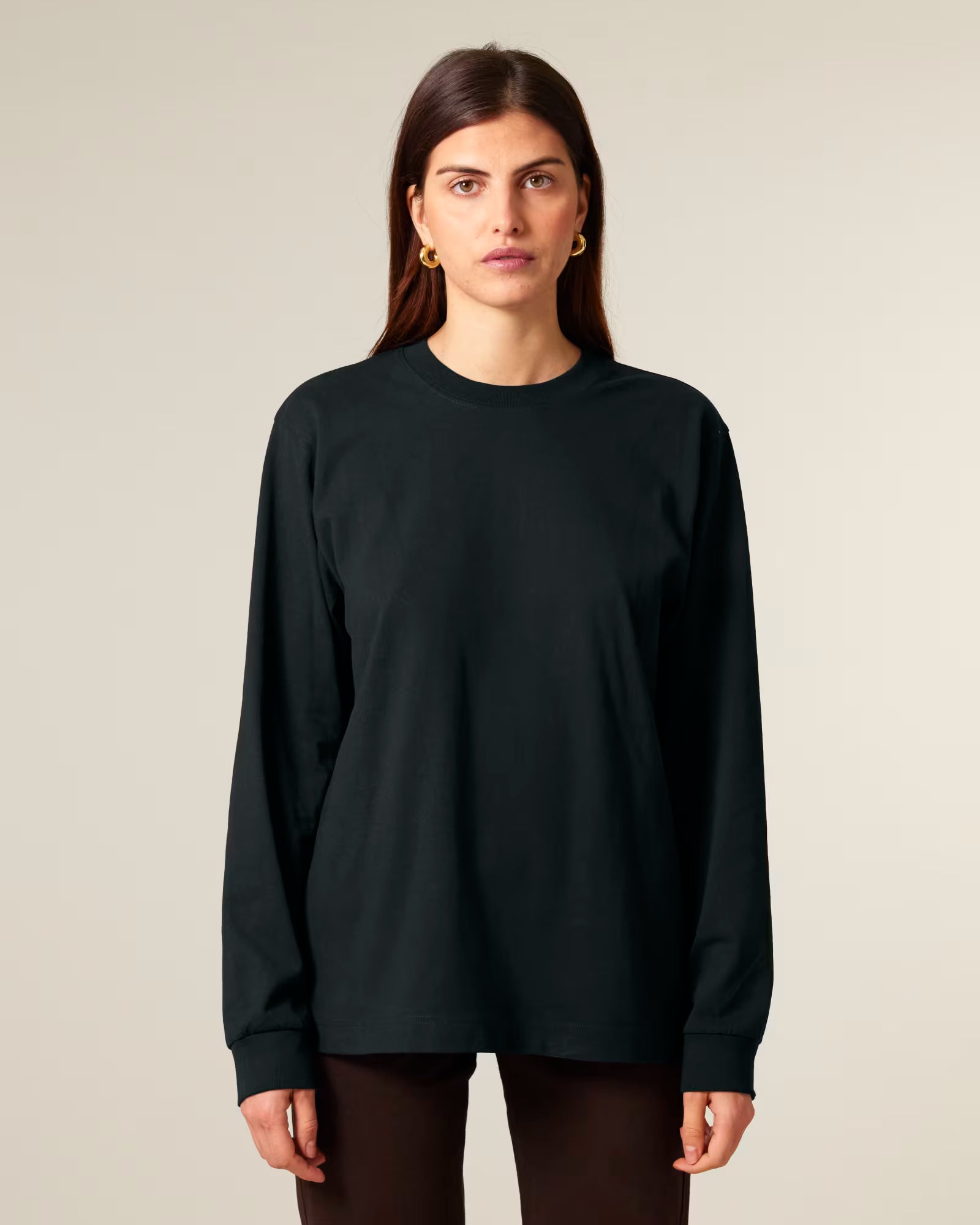 Front view of a female model wearing a black cotton long sleeve t-shirt in studio